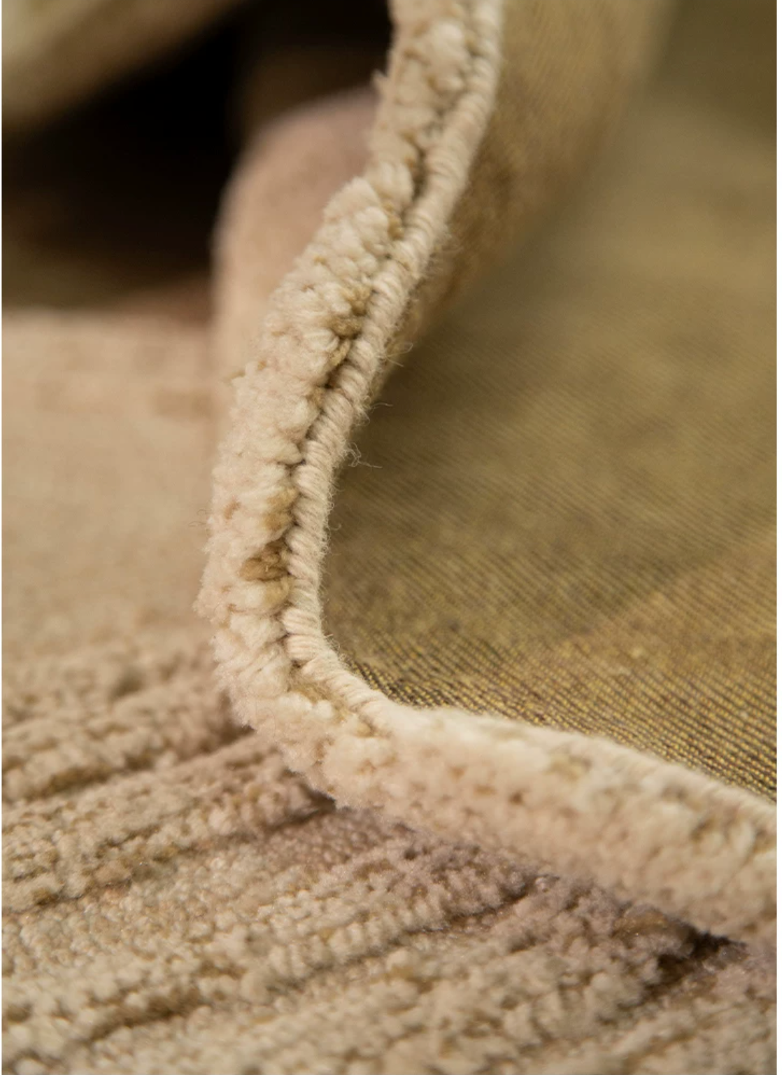 Hewn Earth Studio Camellia rug with clay and bloom pattern, showcasing soft, textured fabric and intricate floral design in a room setting.