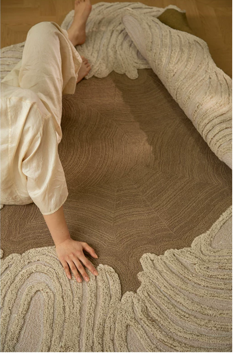 Hewn Earth Studio Camellia clay rug with a floral pattern, showcasing intricate design and warm earthy tones on a neutral background.