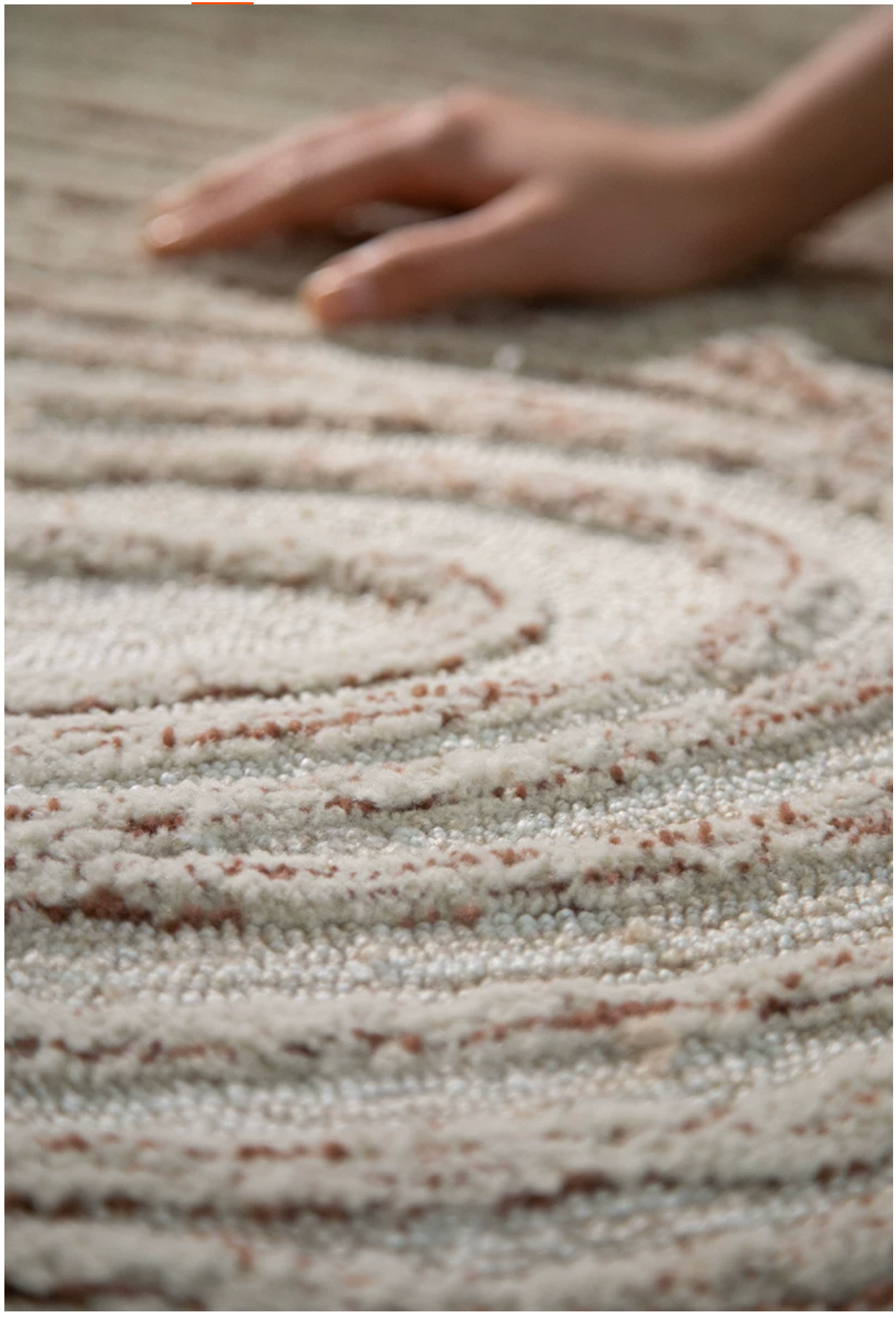 Close-up of the Hewn Earth Studio Camellia rug featuring a detailed cocoa bloom design in rich, warm tones.