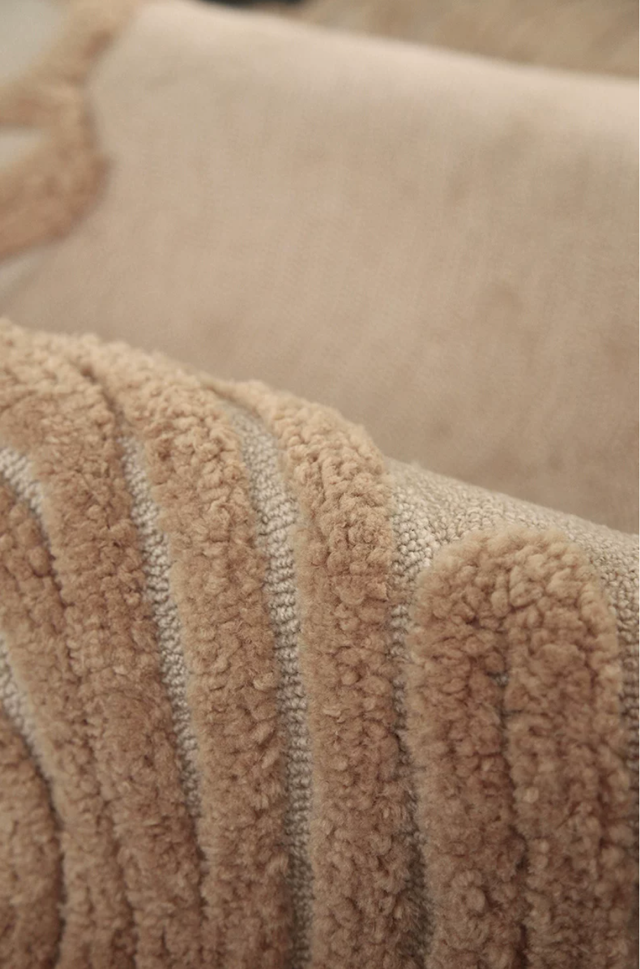 Close-up of Hewn Earth Studio Camellia rug featuring an oat bloom pattern with intricate floral design.