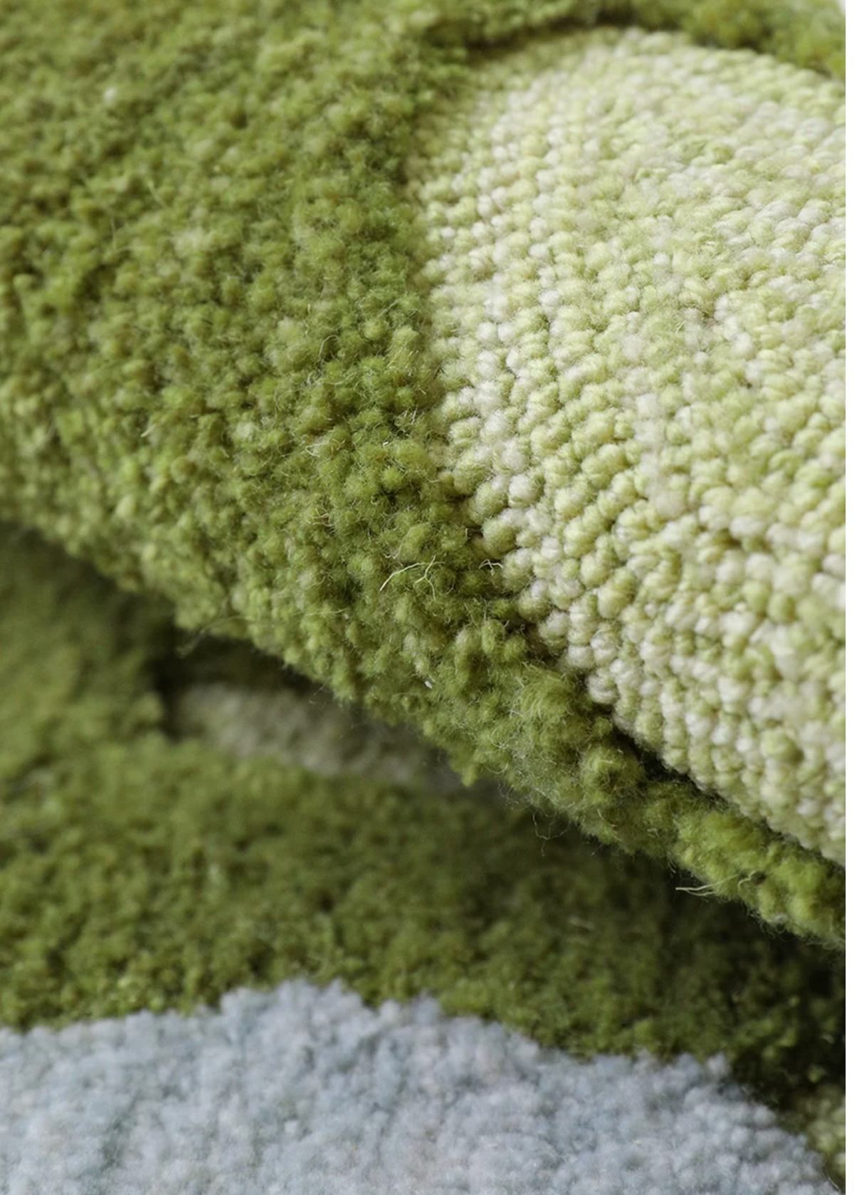 Hewn Earth Studio Fen moss rug with textured green moss pattern, ideal for natural-themed living room decor.