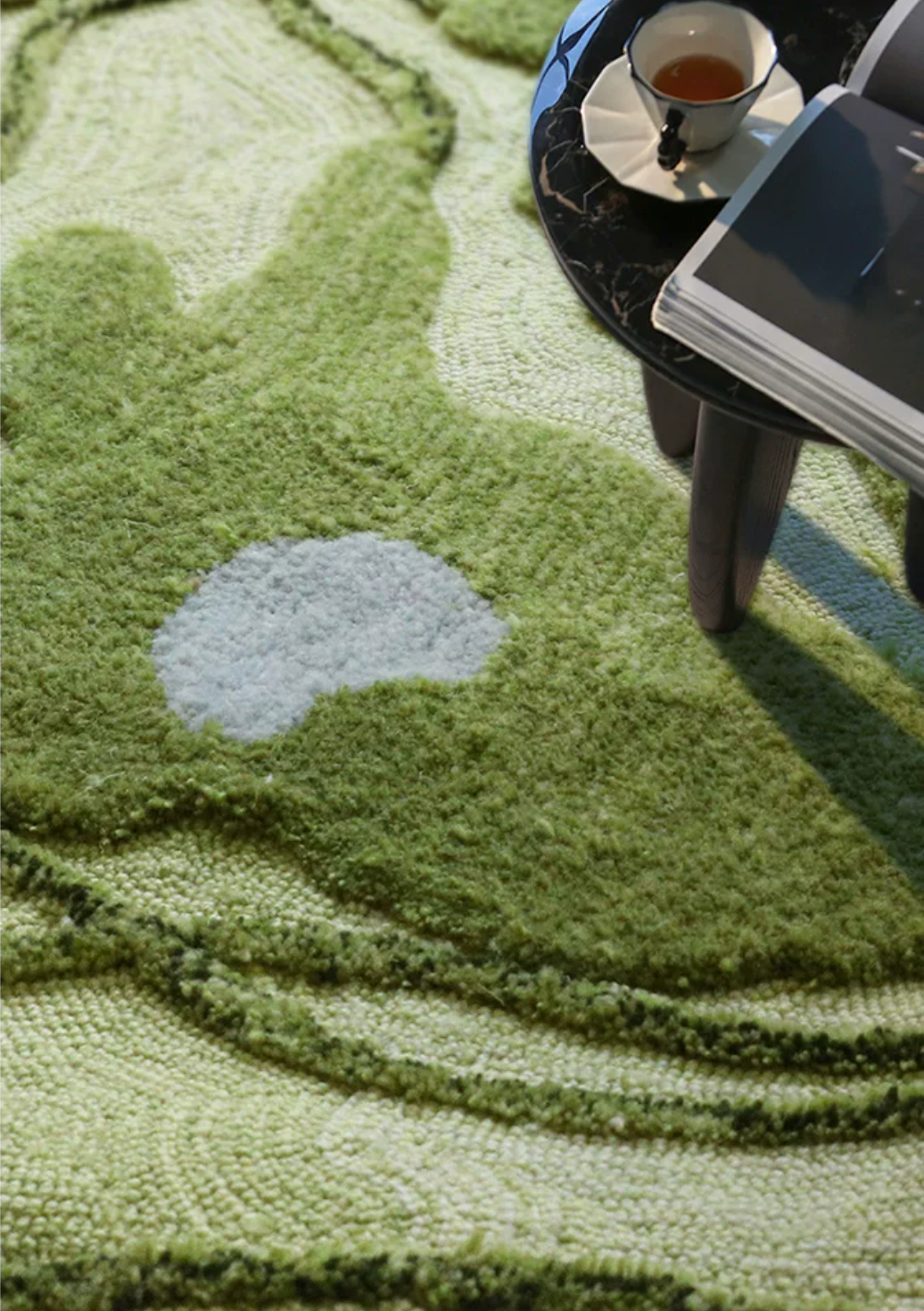 Hewn Earth Studio Fen moss rug shown in a cozy room, featuring soft moss green fibers and textured woven design.