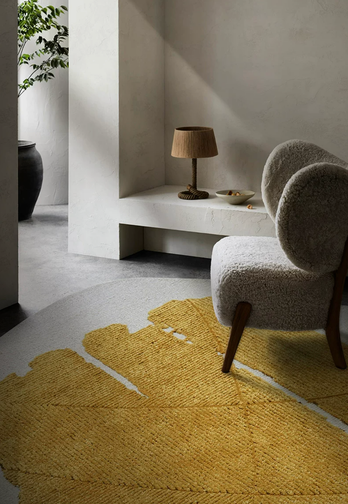 Close-up of Hewn Earth Studio gold leaf foil rug showing shiny, textured metallic surface with intricate details.