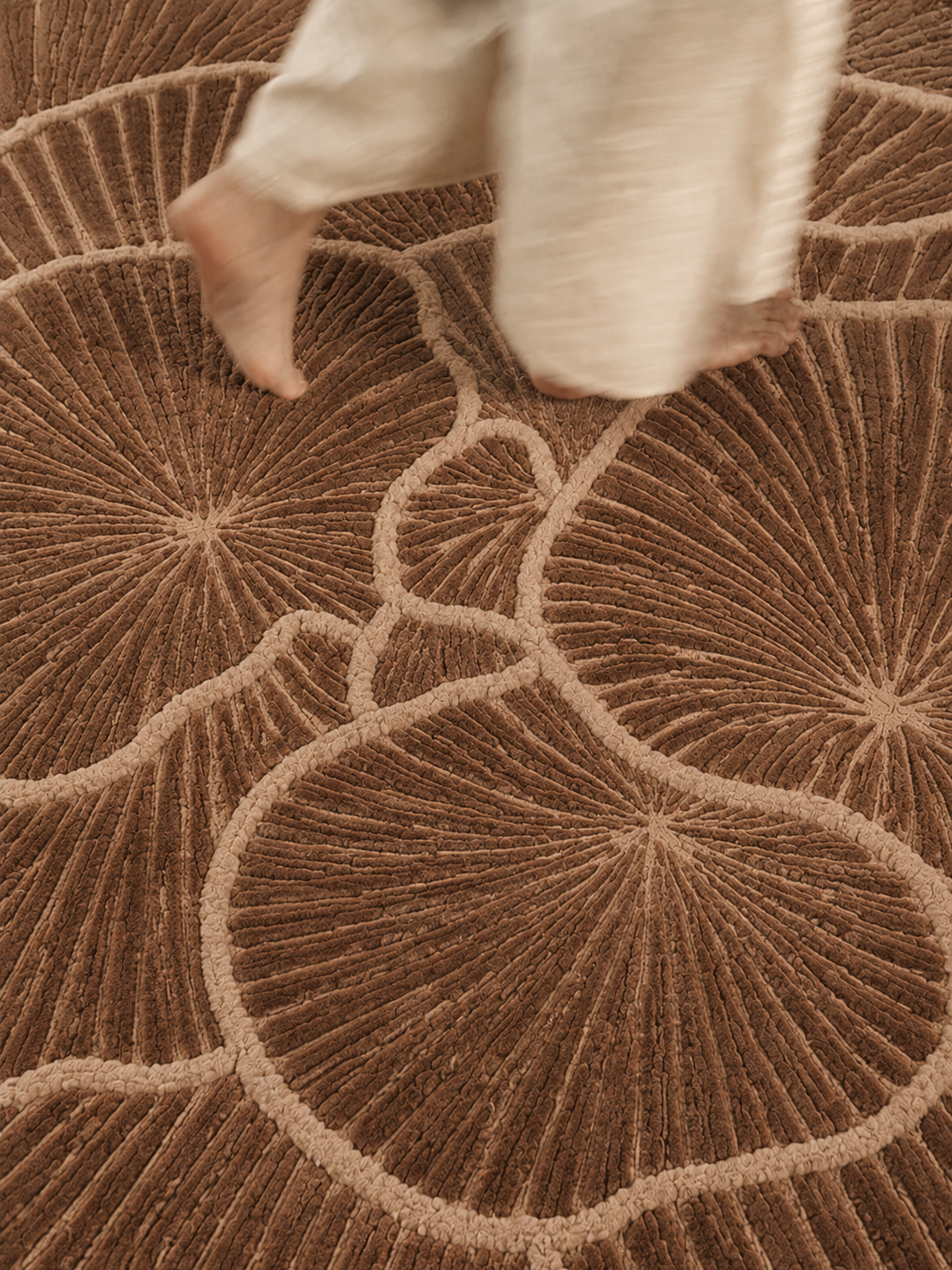 Hewn Earth Studio Frond rug in cocoa with a textured, leafy design, showcasing natural, eco-friendly home decor.
