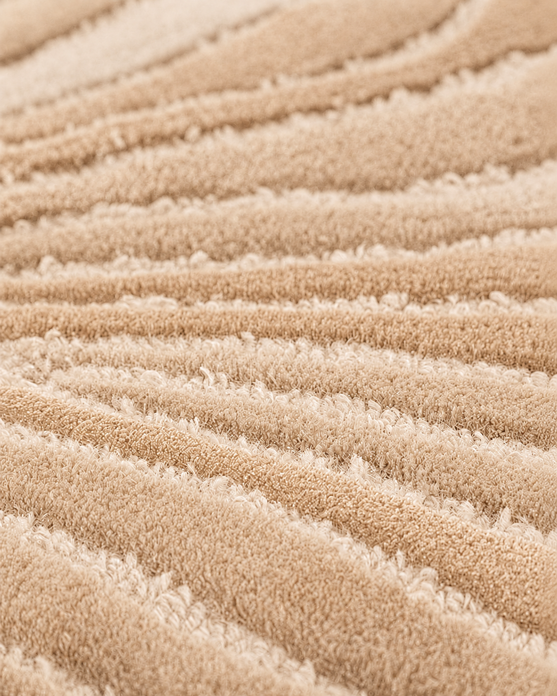 Hewn Earth Studio Frond rug in sand color, showing a detailed close-up of its textured, leaf-inspired design pattern.