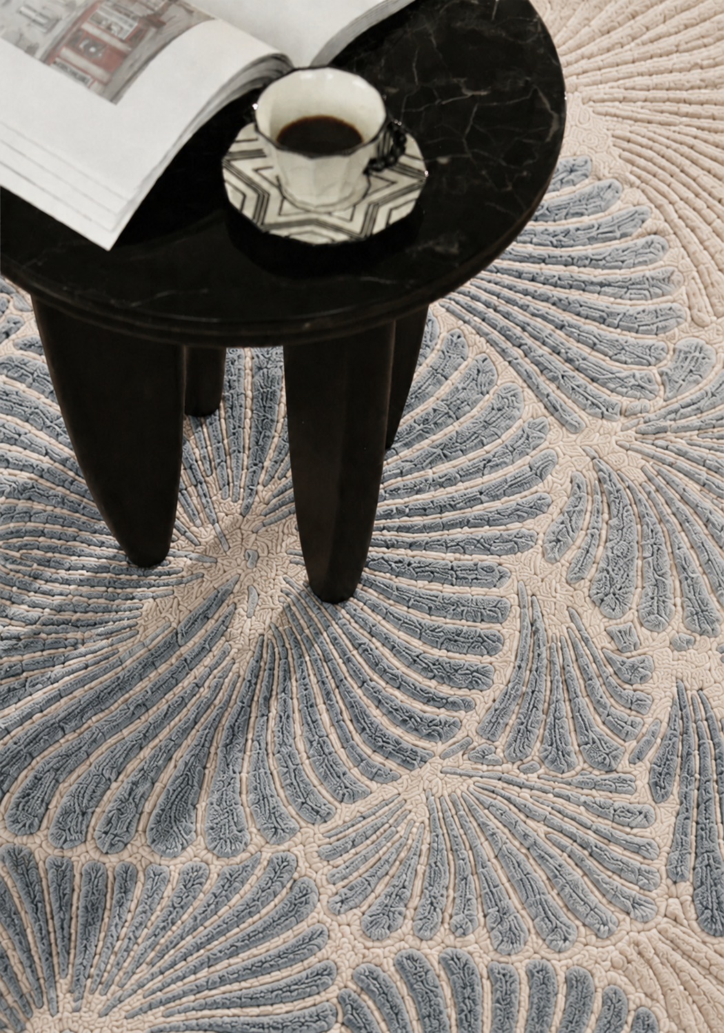 Hewn Earth Studio Frond rug in slate color with intricate leaf pattern, close-up macro shot showing textured design.