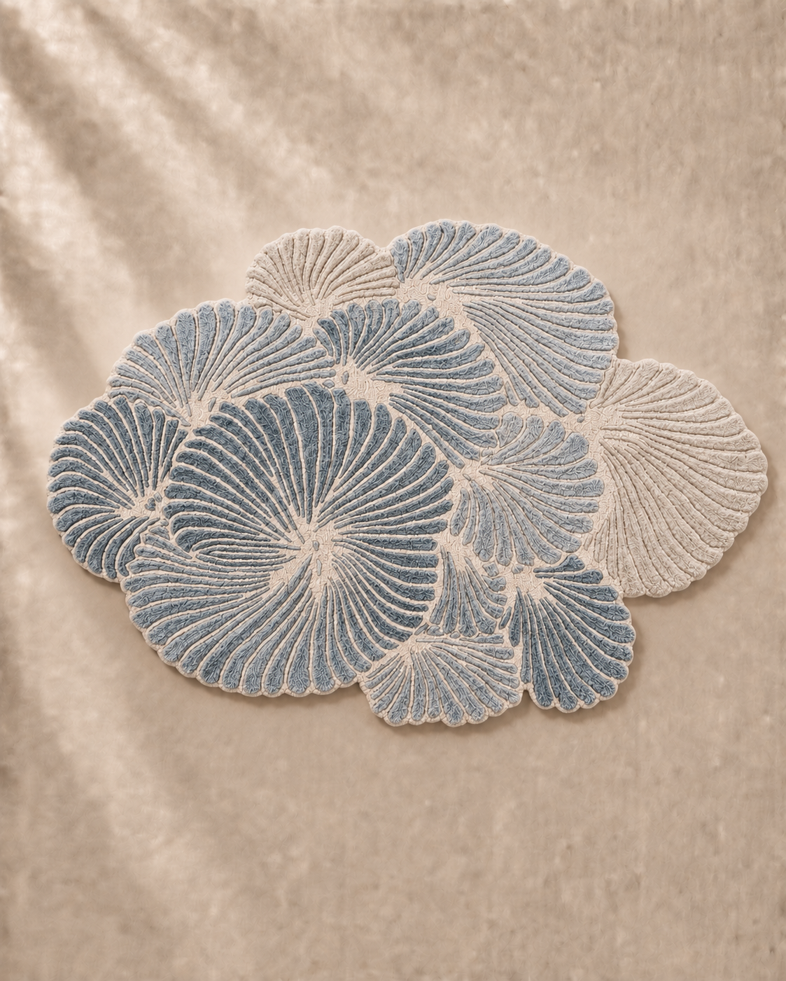 Hewn Earth Studio Frond slate rug with a textured, natural design featuring leaf-like patterns in soft grey tones.