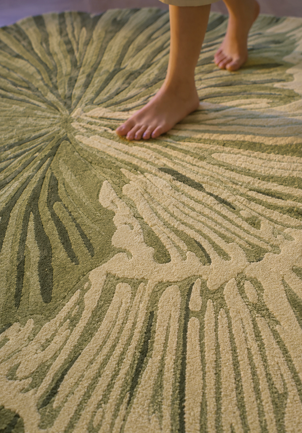 Hewn Earth Studio Lotus rug in fern green showing detailed close-up of textured fabric and woven design.