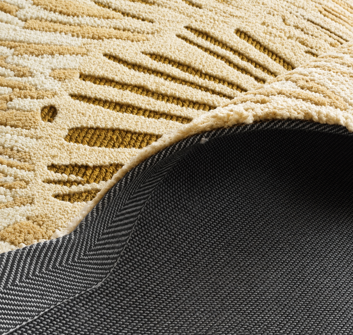 Hewn Earth Studio Lotus rug in golden wheat color, showcasing intricate woven pattern and soft textured fabric from the back view.