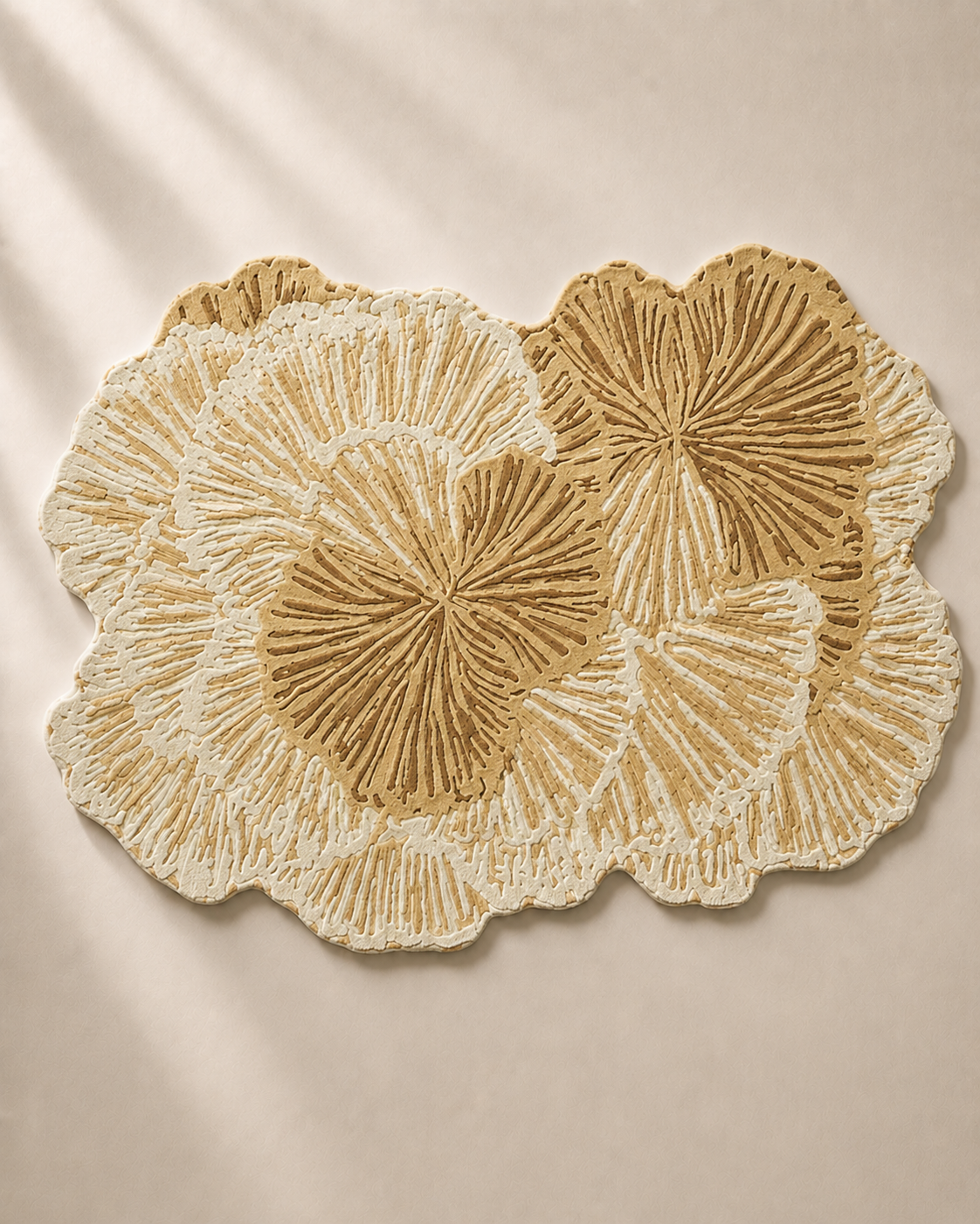 Hewn Earth Studio Lotus rug in golden wheat color, featuring intricate woven floral design, displayed on a chair.