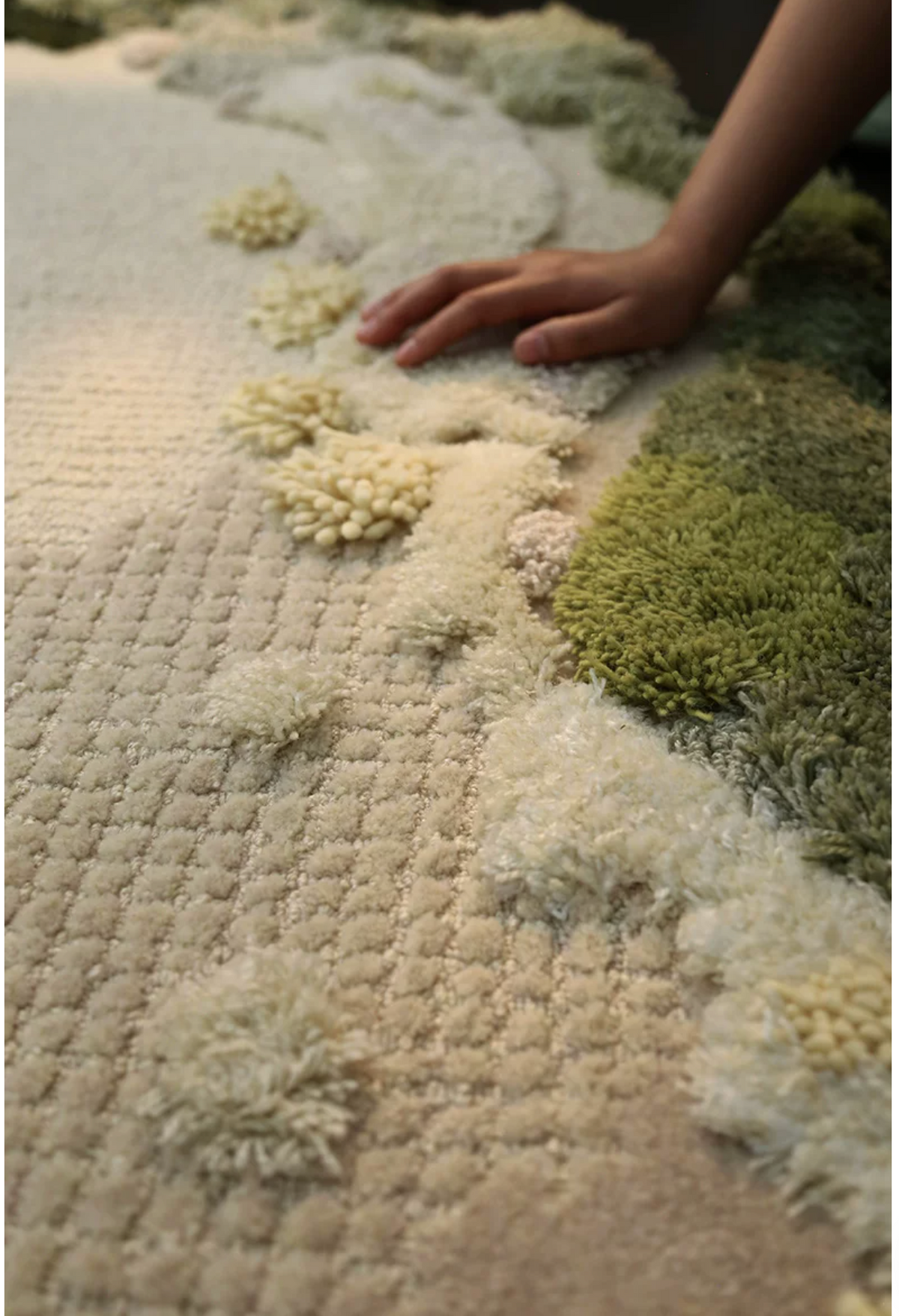 Close-up of Hewn Earth Studio Meadow Moss rug showing detailed woven texture and natural earthy tones.