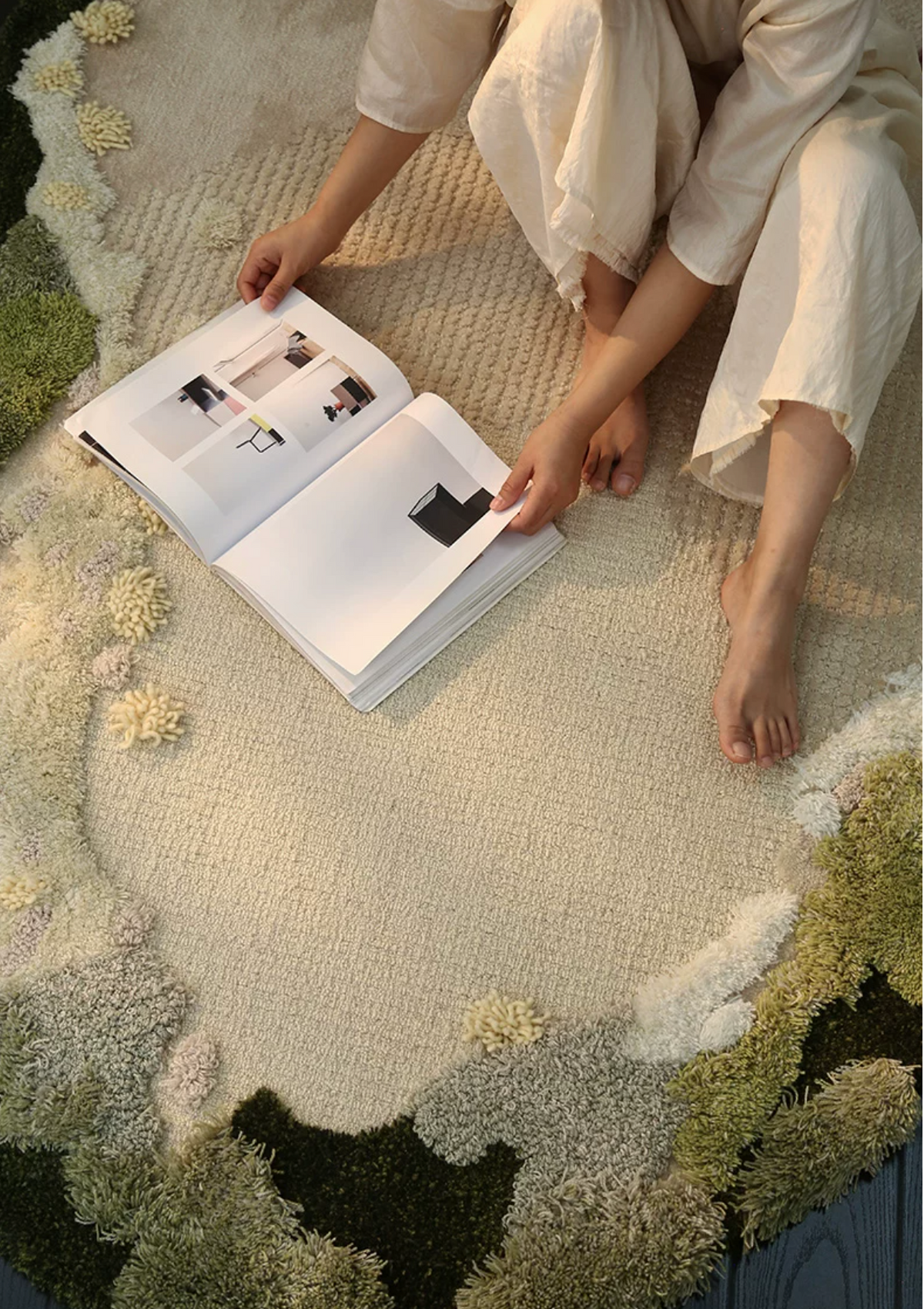 Hewn Earth Studio Meadow moss rug with lush green pattern, shown in a cozy room setting. Ideal for adding natural texture to a space.