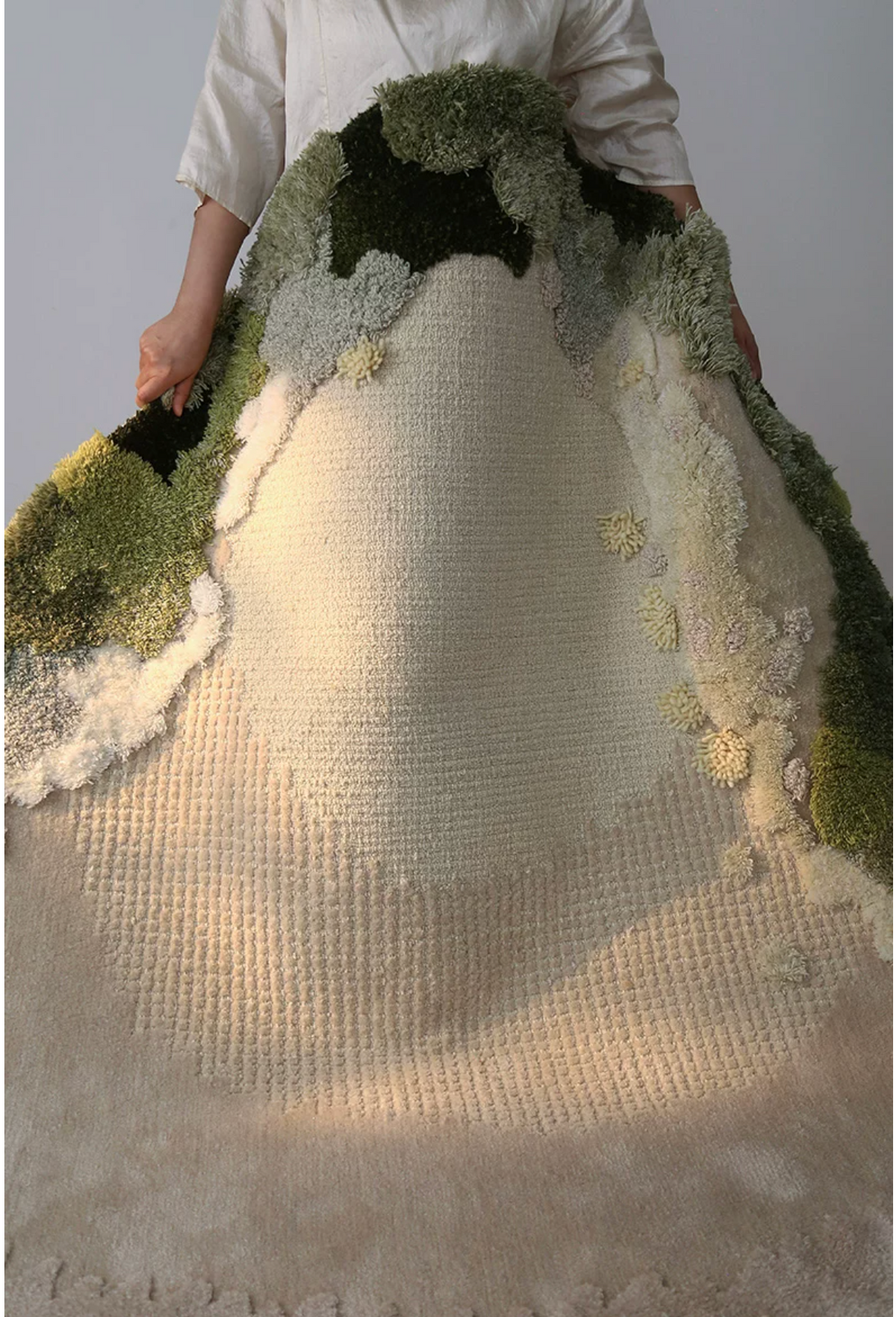 Hewn Earth Studio Meadow moss rug displayed from the side showing textured woven design and natural earthy tones.
