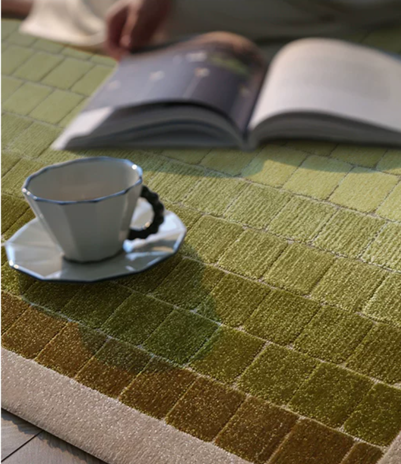 Hewn Earth Studio mosaic rug with moss green gradient pattern, detailed close-up showing textured woven design.