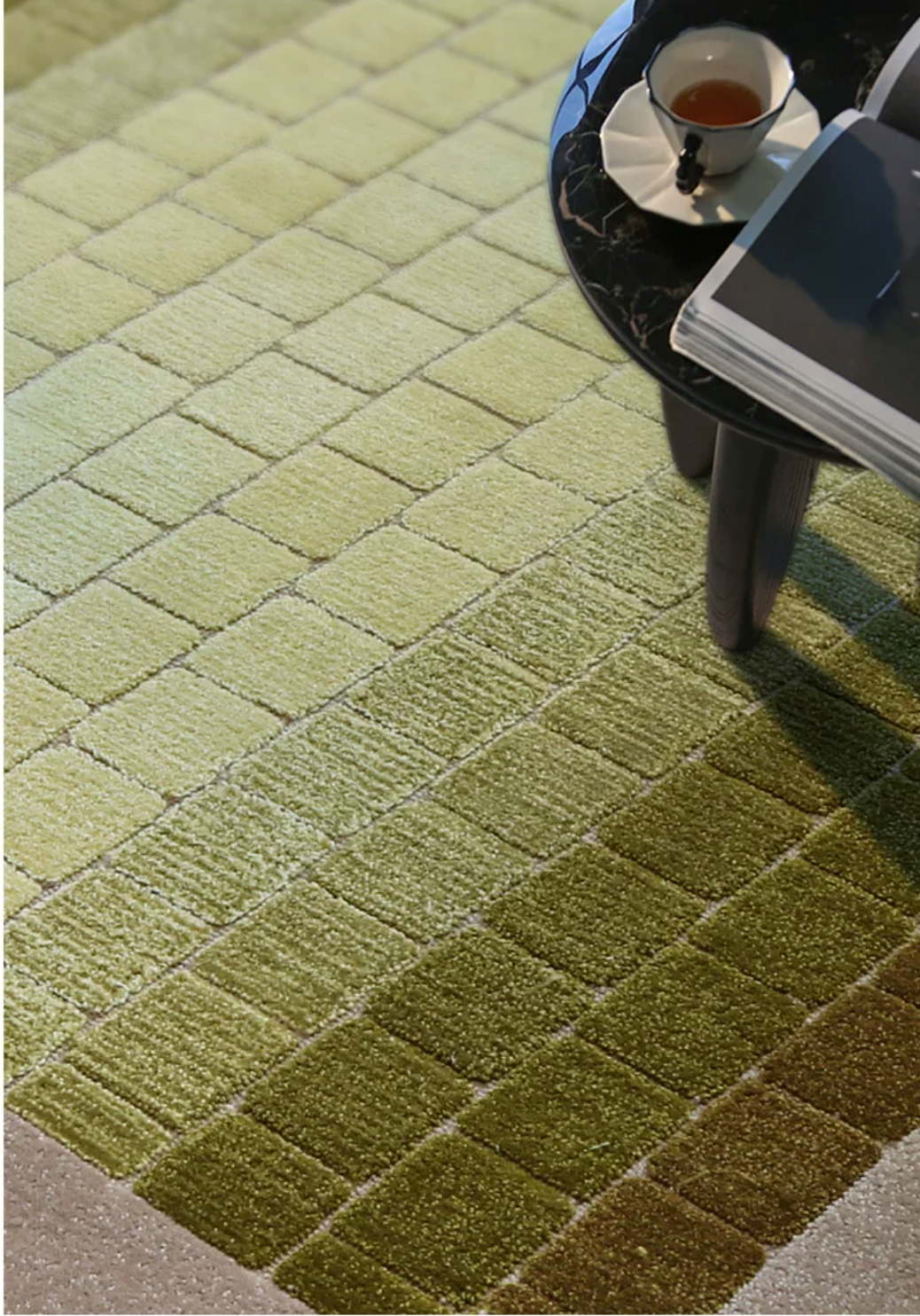 Hewn Earth Studio mosaic rug with moss green gradient design, featuring intricate mosaic patterns on a soft textile surface.