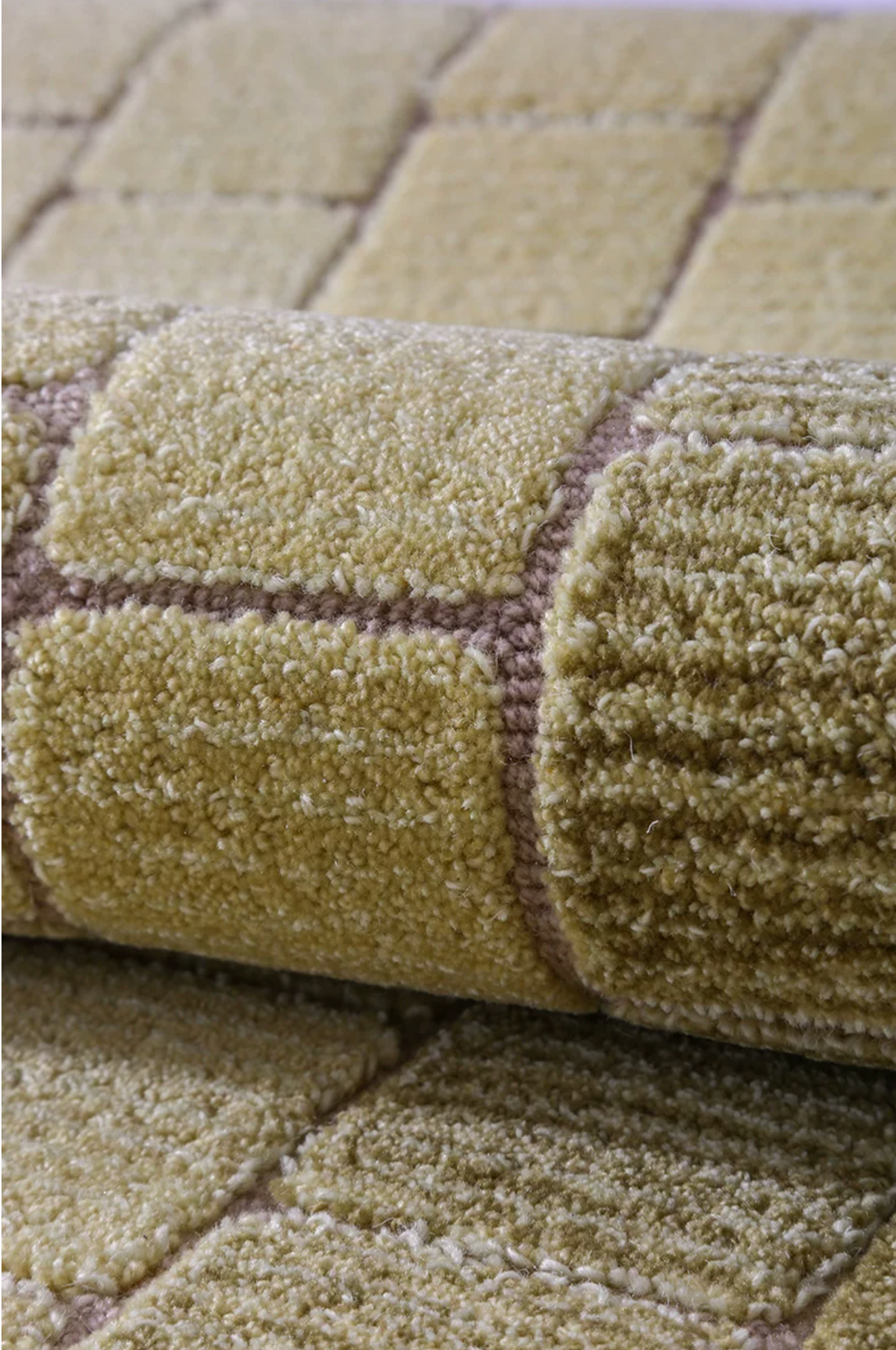 Hewn Earth Studio mosaic rug with moss green gradient design, showcasing intricate patterns and textured surface.