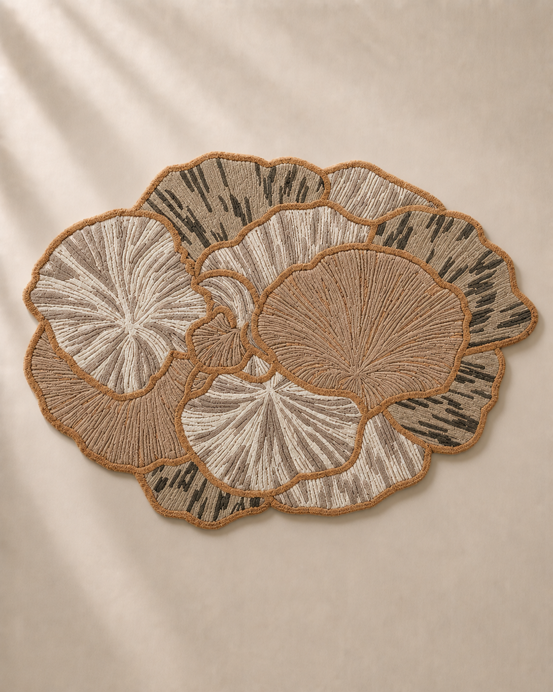 Hewn Earth Studio Petal rug in ash and rust colors with floral petal pattern, soft woven textile for living room decor.
