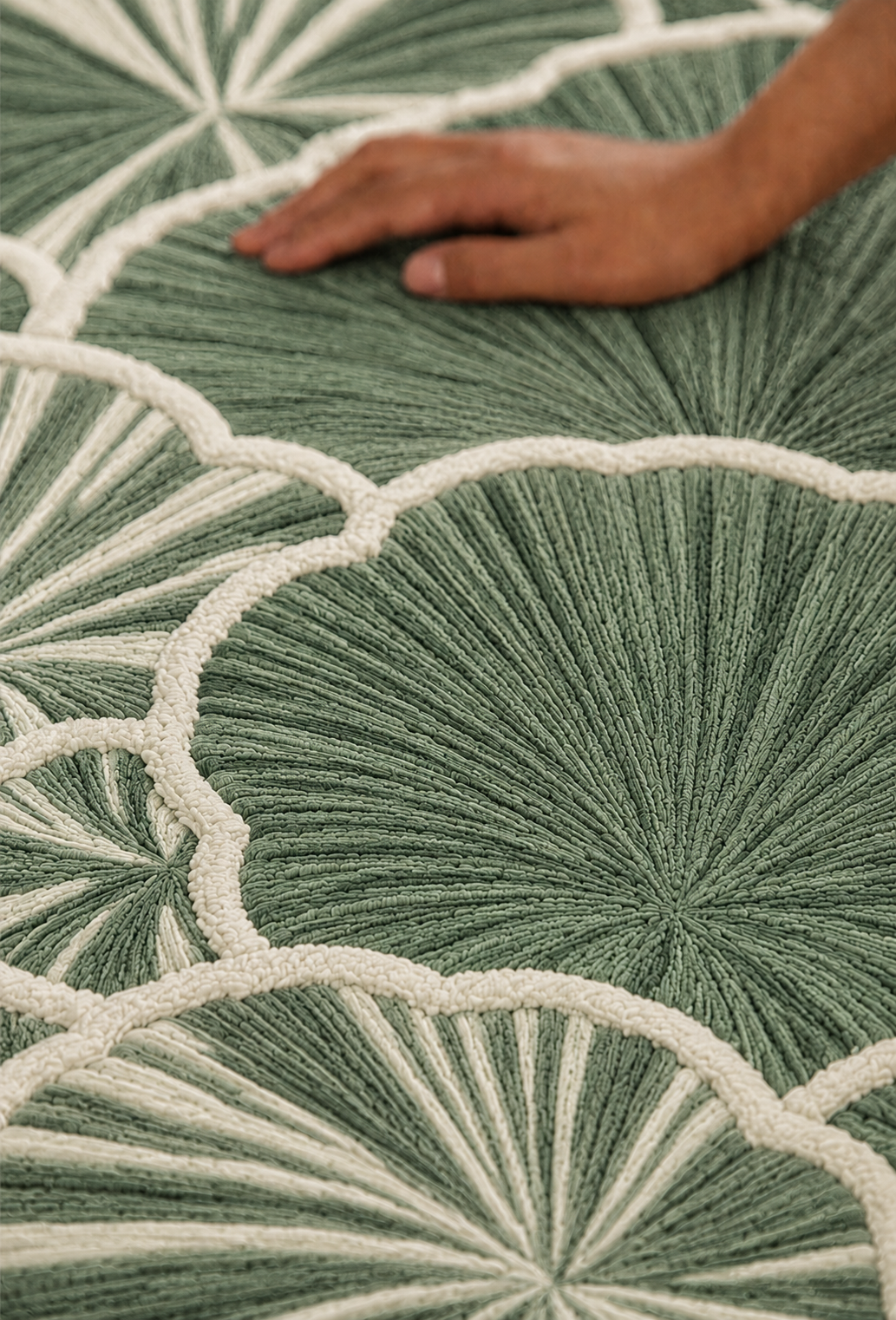 Hewn Earth Studio Petal rug in sage and cream with floral petal pattern, showcasing soft, textured woven design for cozy home decor.