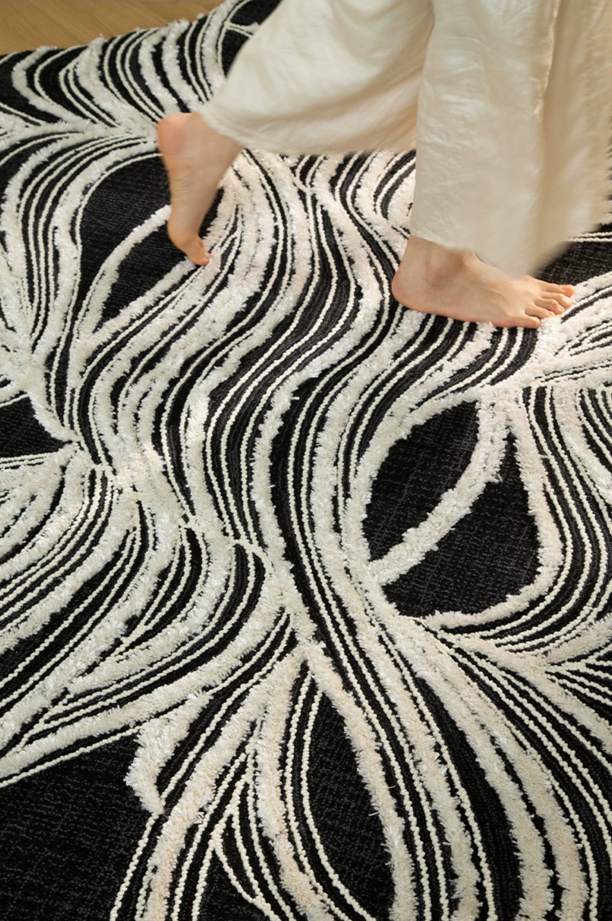 Hewn Earth Studio Plume rug with ink and bone pattern, showcasing intricate design and soft textile texture on a neutral background.