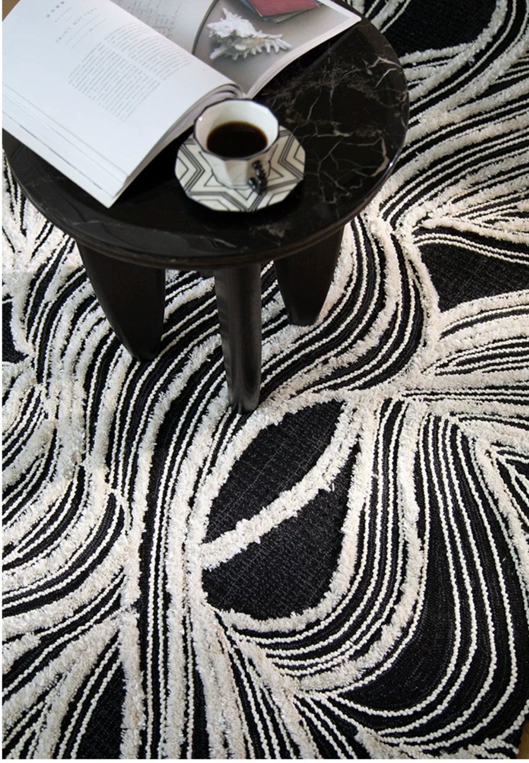 Hewn Earth Studio Plume rug featuring ink and bone colors, shown draped on feet for size and texture display.