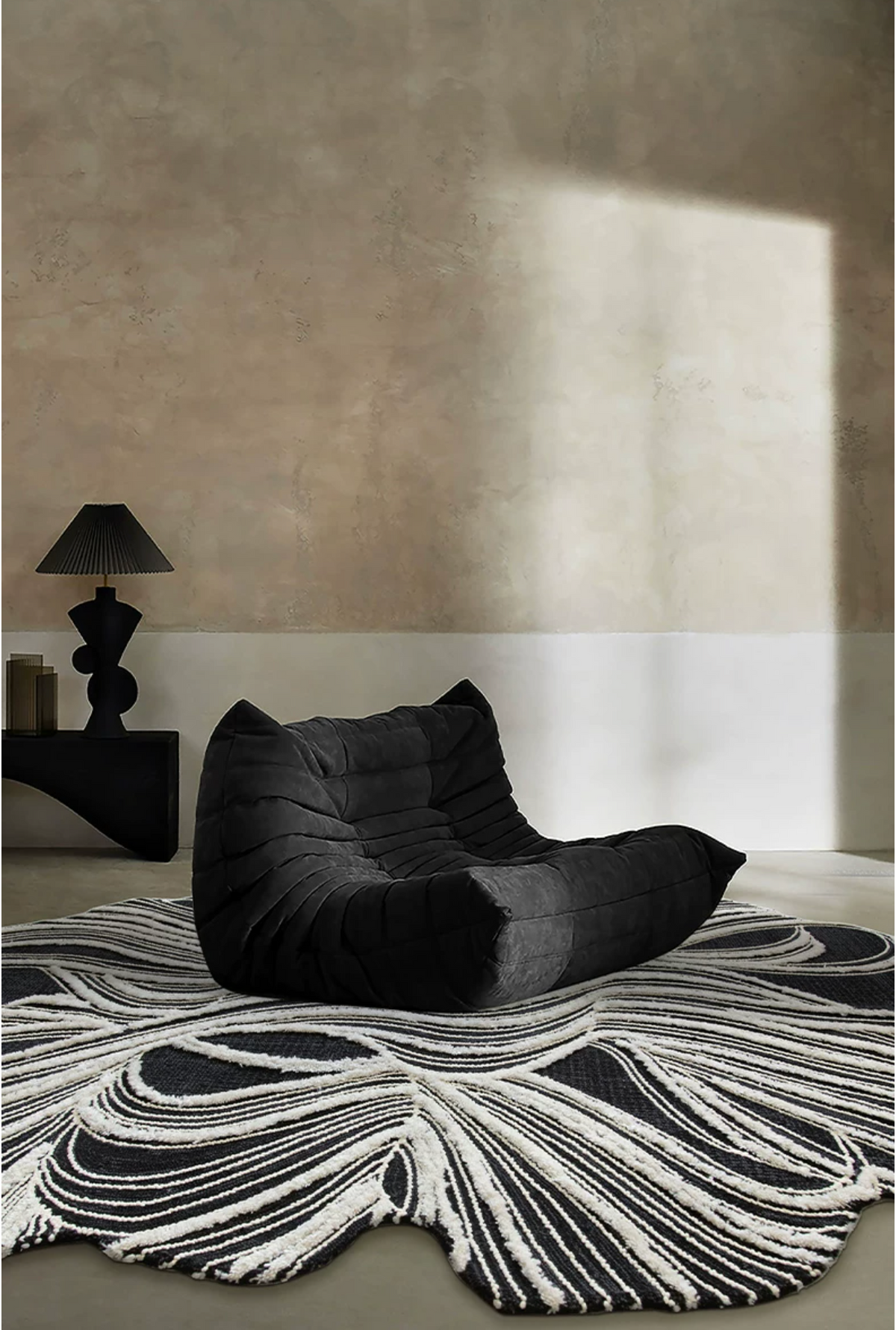 Hewn Earth Studio Plume rug featuring an ink and bone-colored abstract pattern on a soft woven surface.