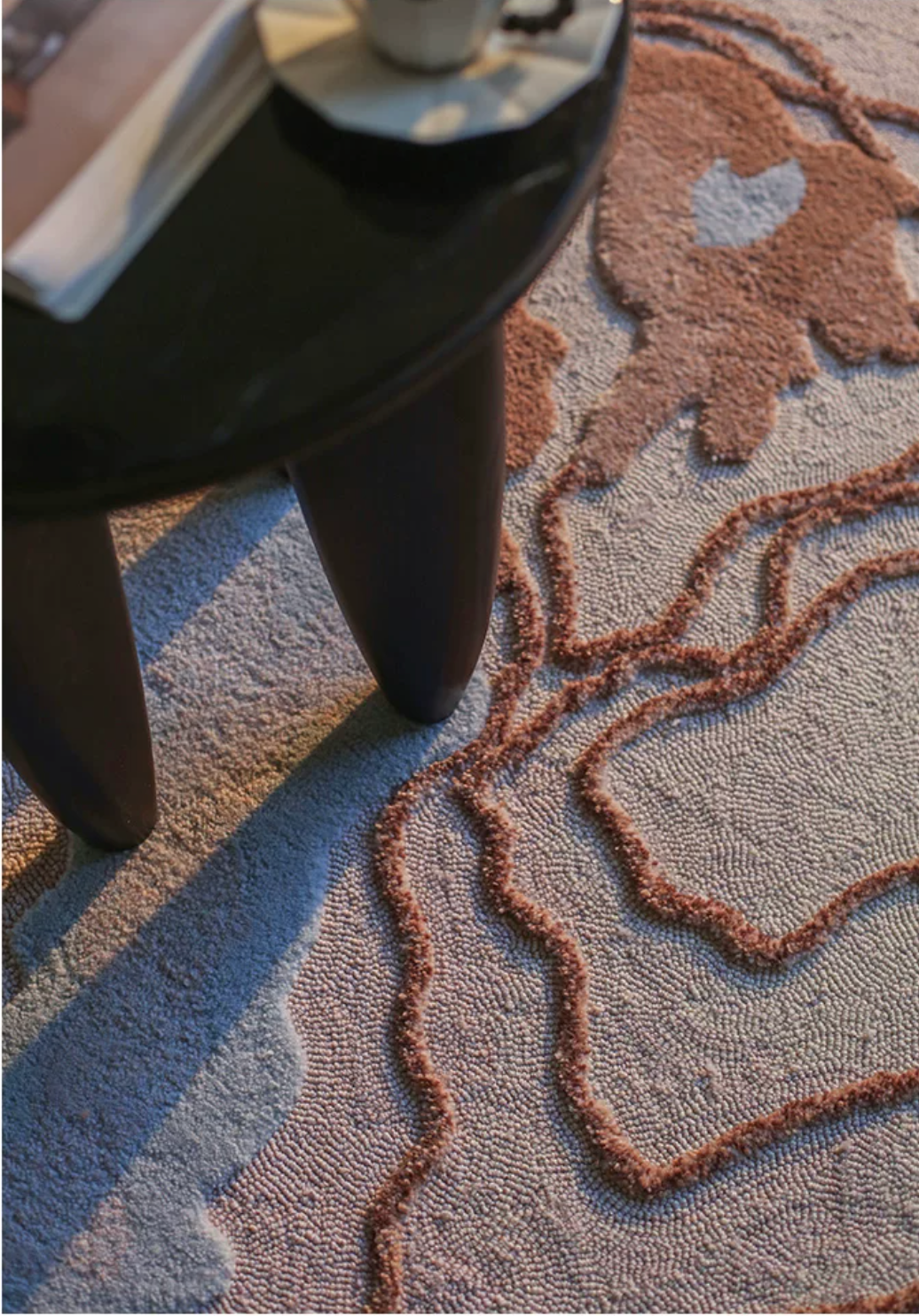 Close-up of the Hewn Earth Studio Strata rug featuring Canyon pattern with textured, earthy design and intricate woven details.