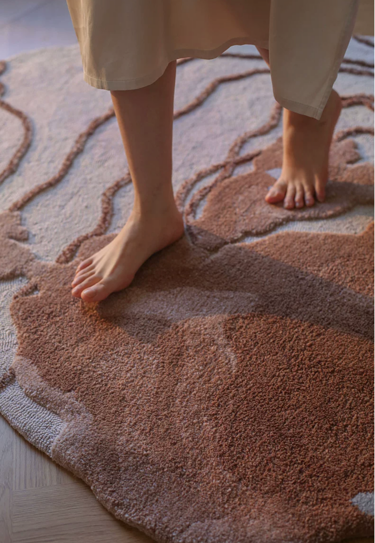 Hewn Earth Studio Strata Canyon rug with earthy tones and textured design, displayed on a reading nook floor.