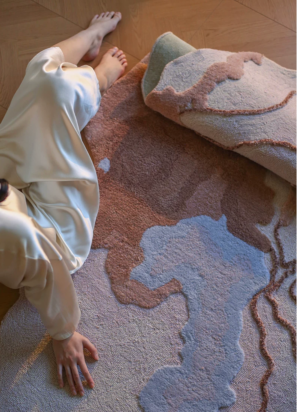 Hewn Earth Studio Strata Canyon rug with earthy tones and textured geometric patterns in a cozy room setting
