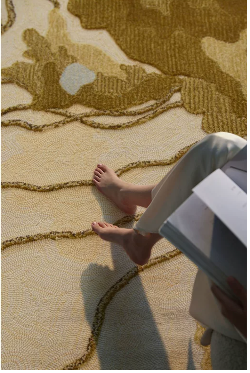 Hewn Earth Studio Strata rug in ochre with handwoven textured pattern, featuring earthy tones and intricate design details.