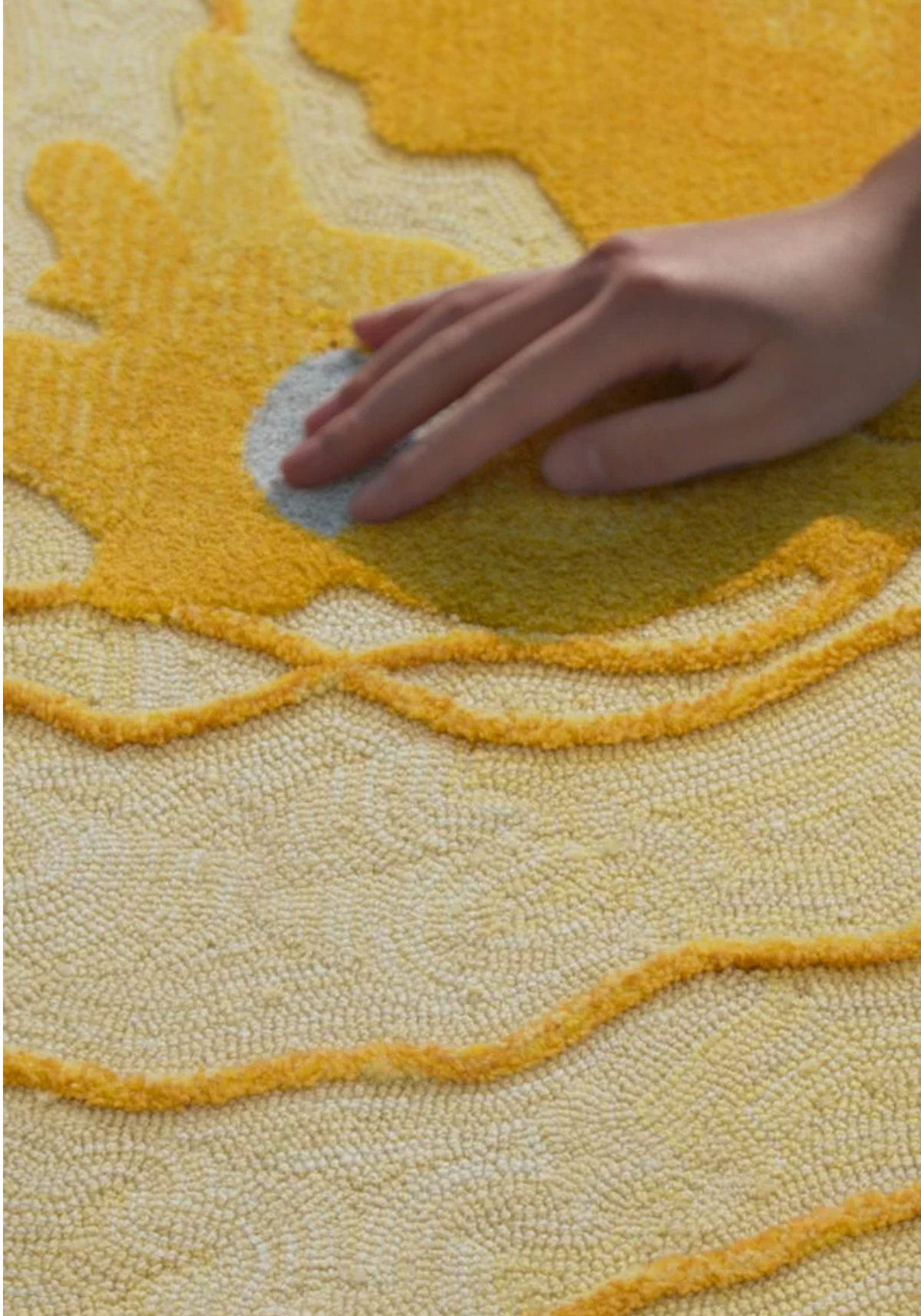 Hewn Earth Studio Strata handwoven rug in saffron with geometric patterns, showcasing intricate textile design.
