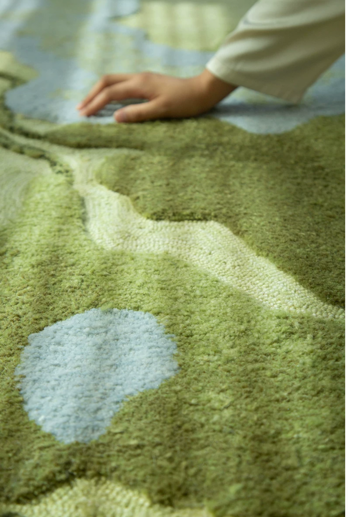 Hewn Earth Studio Strata handwoven rug in verdant green with intricate geometric patterns, showcasing detailed craftsmanship.