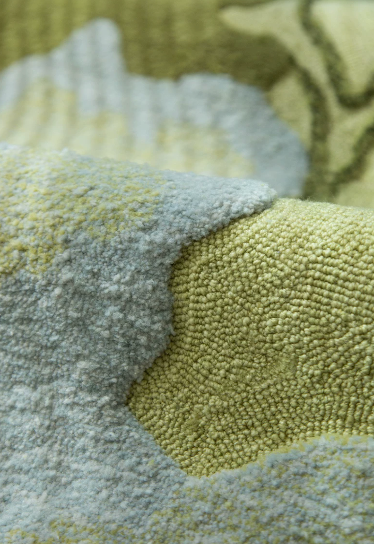 Close-up of Hewn Earth Studio's Strata rug in Verdant, showcasing intricate woven patterns and rich green tones.