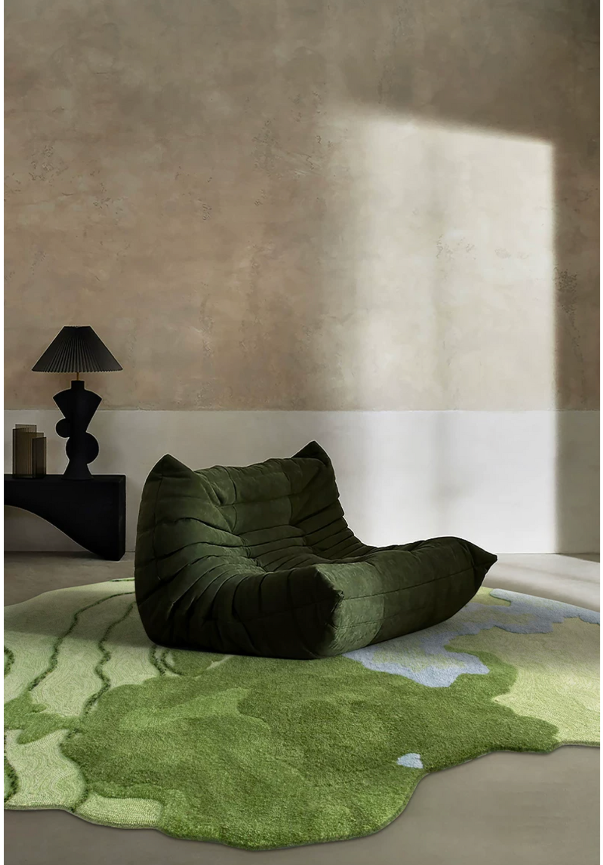 Hewn Earth Studio Strata Verdant rug with geometric pattern, featuring green and neutral tones in a cozy living room setting.