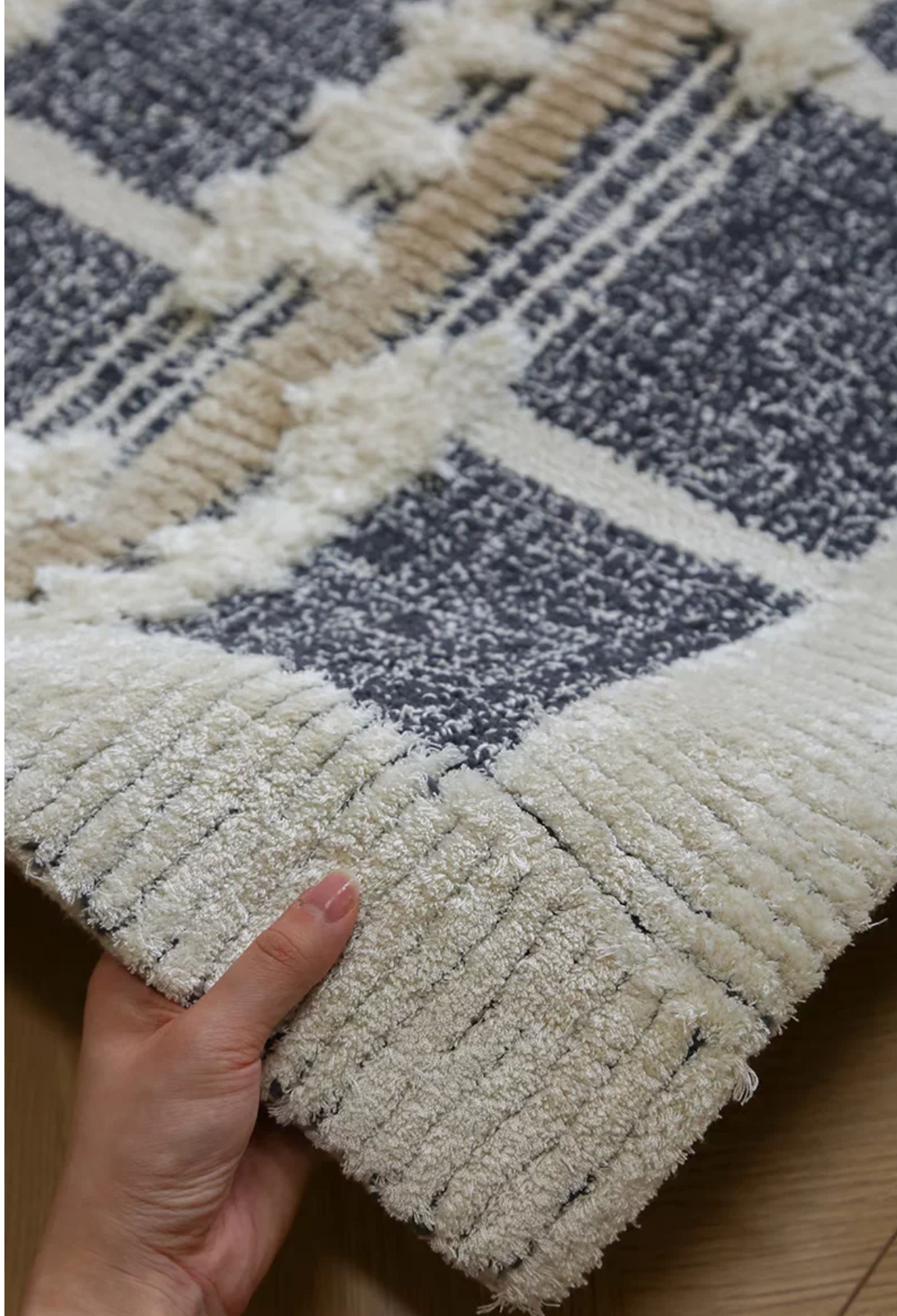 Hewn Earth Studio tartan charcoal handwoven rug with a grid pattern, showcasing textured fabric and intricate design.