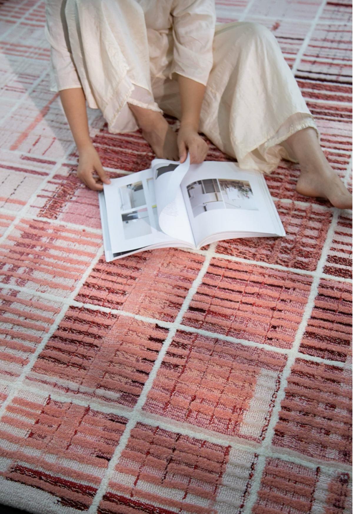 Close-up of a Hewn Earth Studio Weft rug in rose, showcasing detailed woven textile pattern and texture.