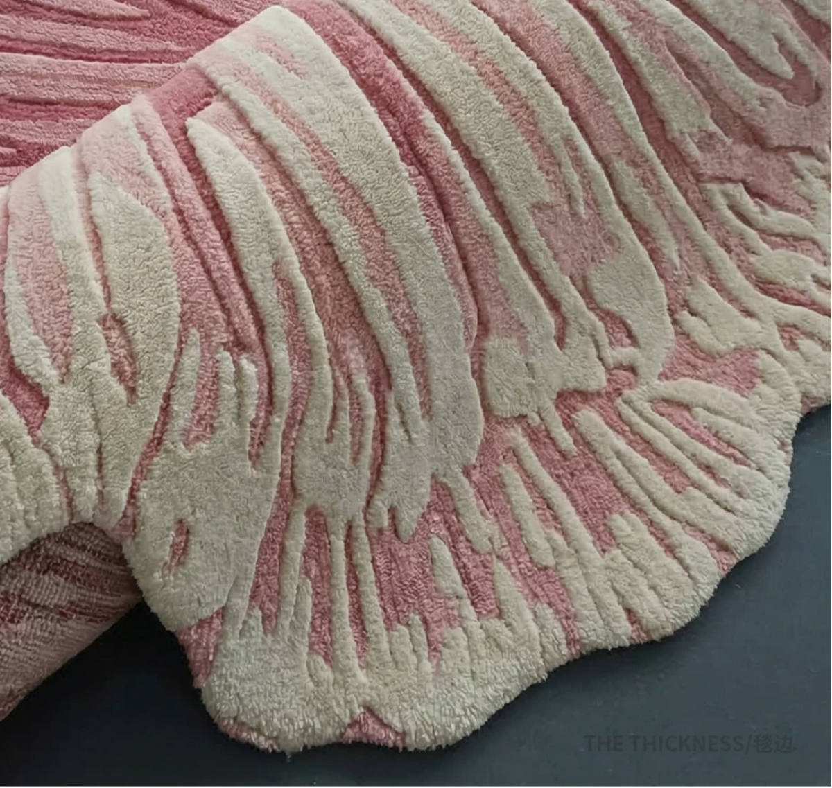 Hewn Earth Studio Solene rug with anemone-edge design showcasing intricate floral patterns on soft fabric.
