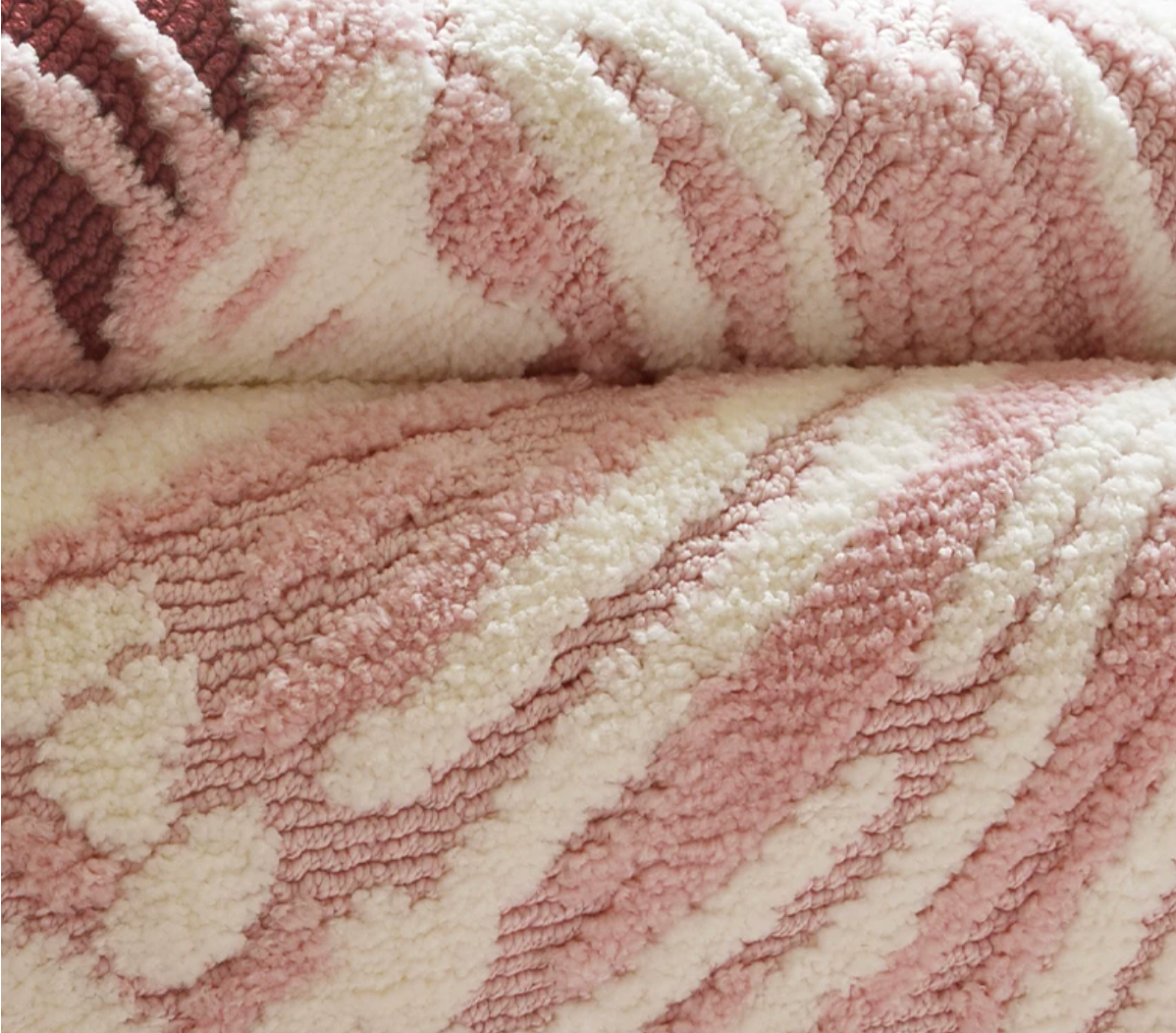 Close-up of the Solene Hewn Earth Studio rug featuring detailed anemone-inspired woven pattern in natural fibers.