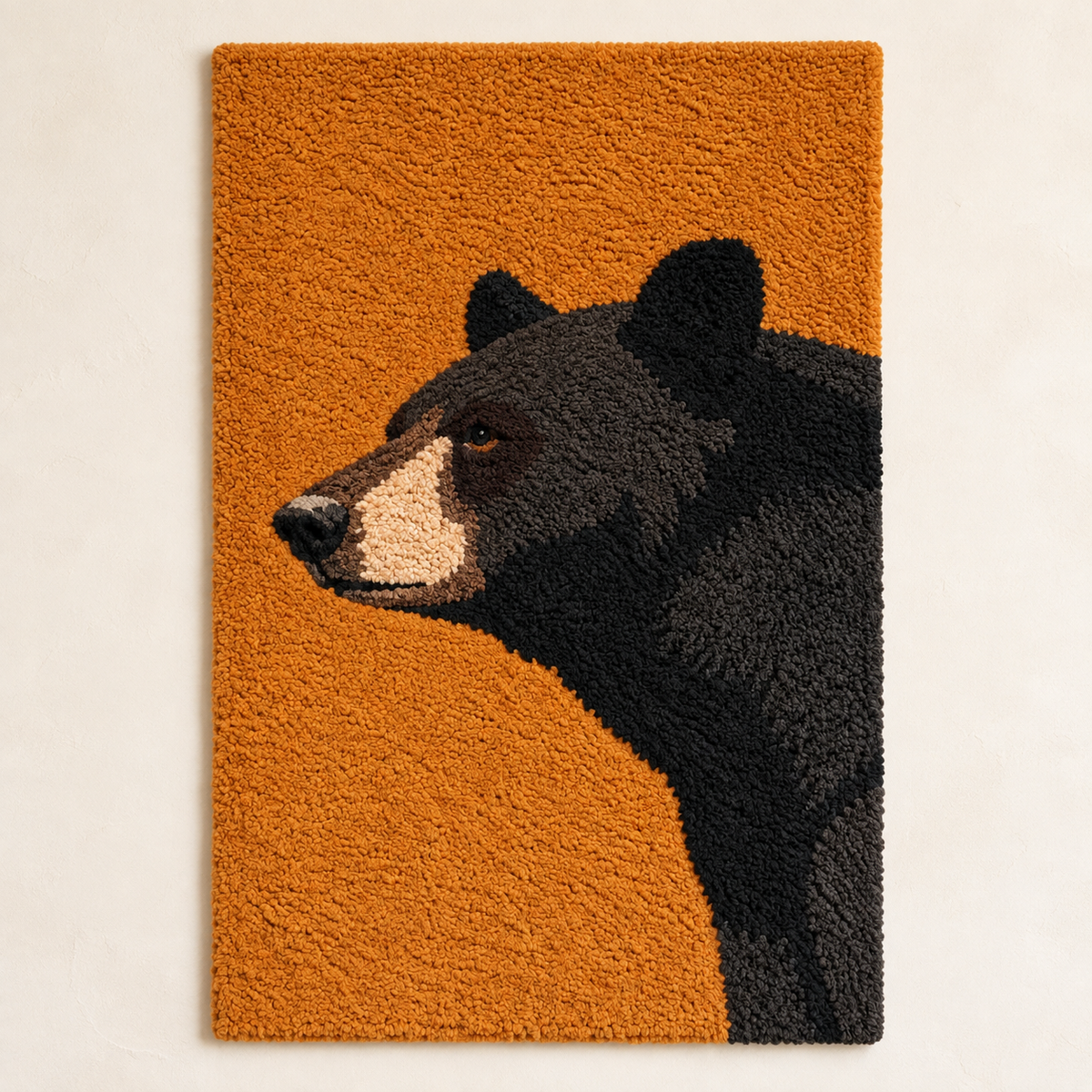 Black bear wall art on amber by Hewn Earth, featuring a detailed black bear design on warm amber background.