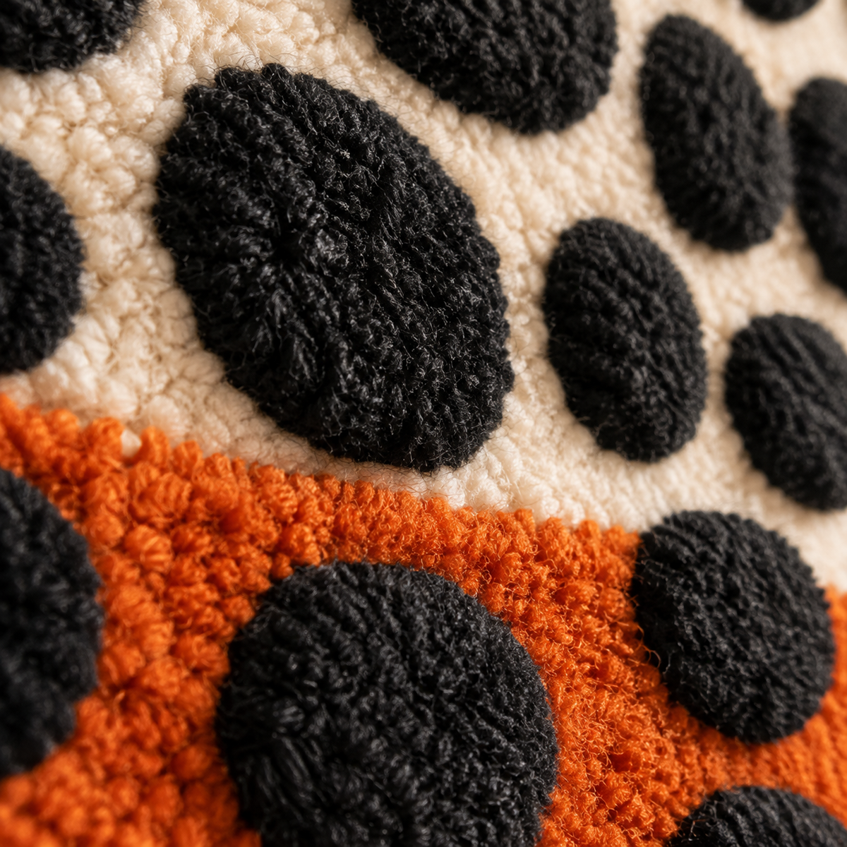 Close-up of Hewn Earth wall art featuring black pebbles layered over a textured clay horizon.