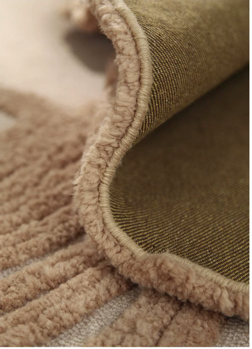 Hewn Earth Studio Camellia rug, back view showing intricate floral pattern and soft woven texture on a neutral background.