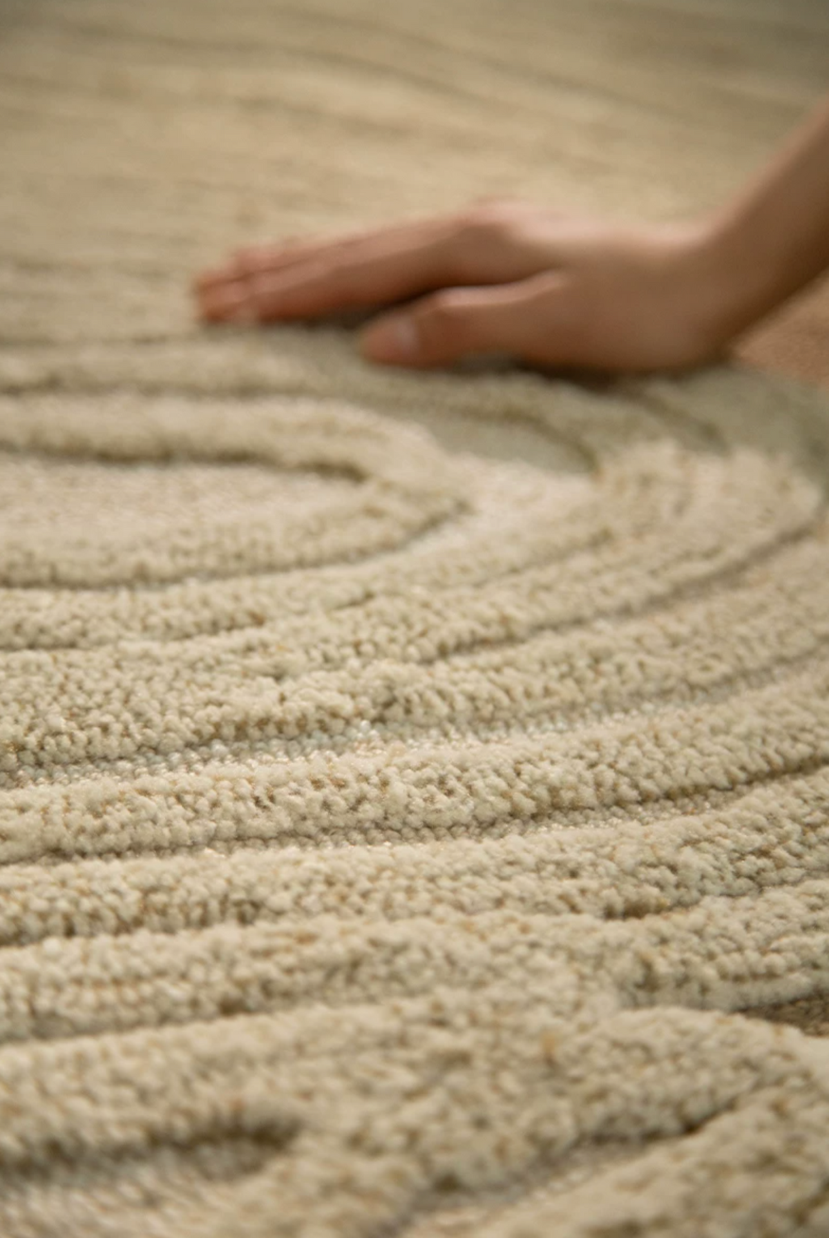 Hewn Earth Studio Camellia hand-woven clay rug with intricate patterns and earthy tones, showcasing craftsmanship and natural texture.