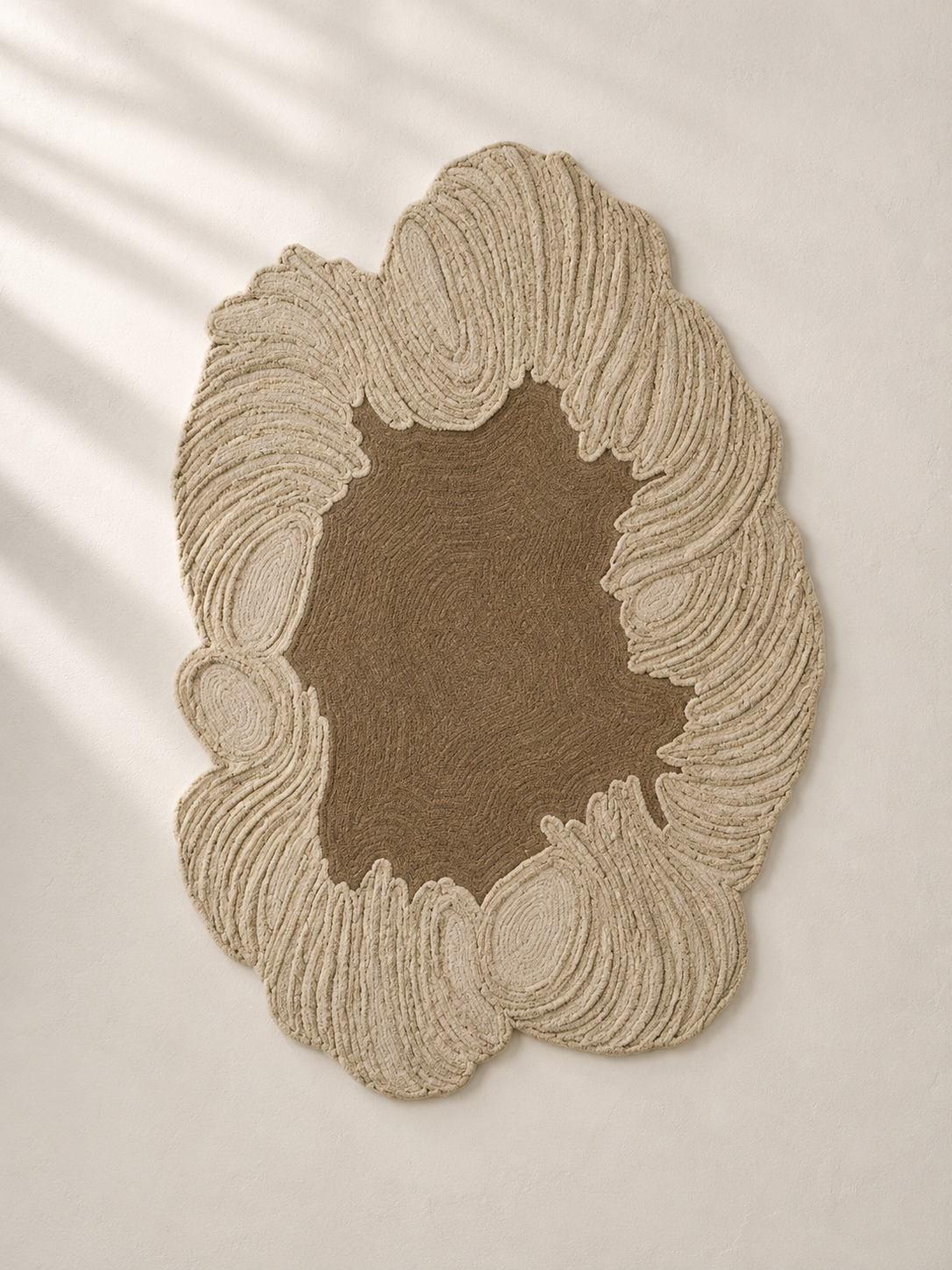 Hewn Earth Studio Camellia rug featuring a soft, textured clay-colored design with intricate patterns on a woven surface.