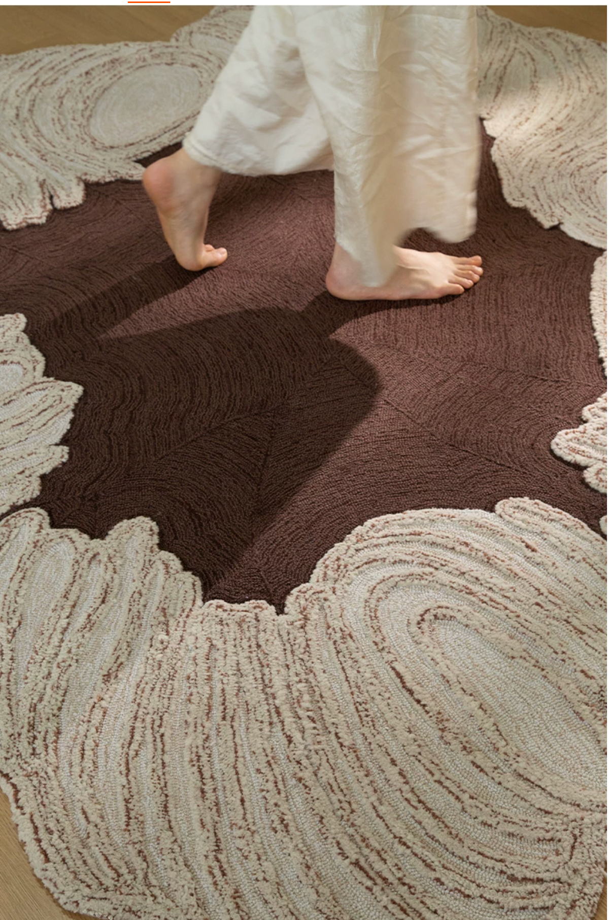 Hewn Earth Studio Camellia rug in cocoa color with handwoven texture, showcasing intricate design and soft fabric.
