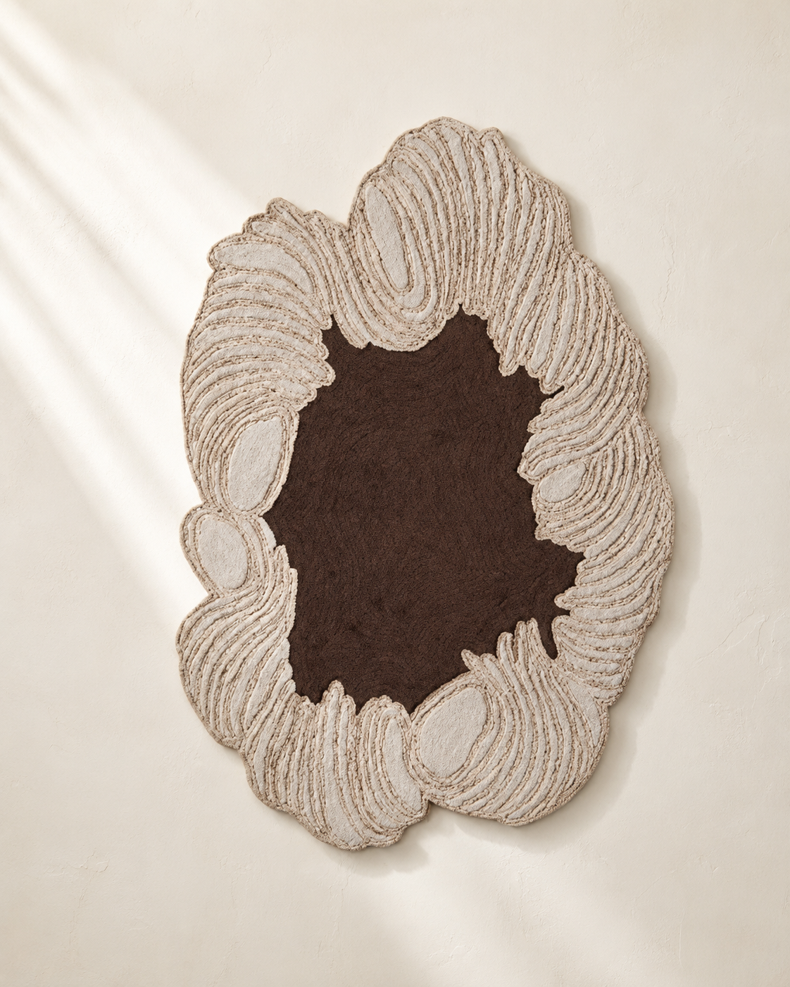 Hewn Earth Studio Camellia rug with a cocoa-colored floral pattern, showcasing intricate design and soft woven texture.