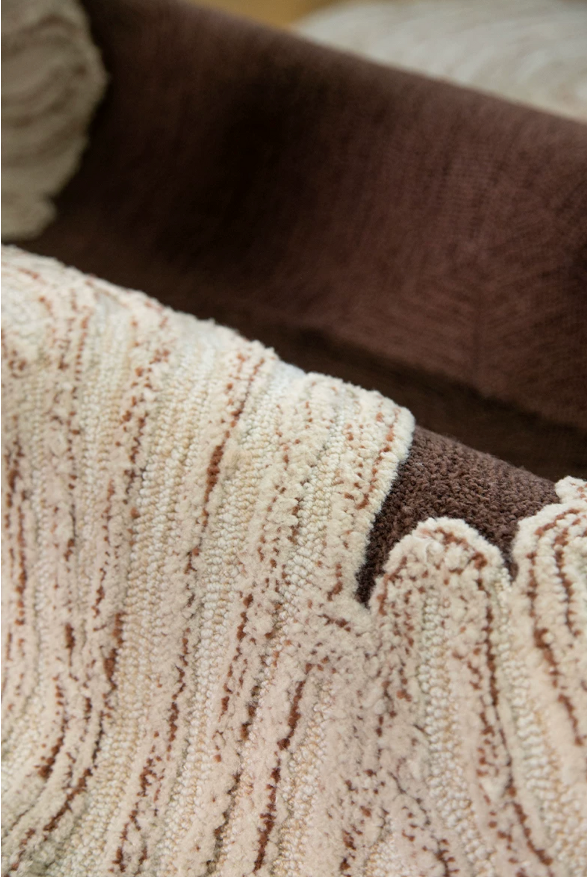 Hewn Earth Studio Camellia rug in cocoa color with floral pattern, showcasing intricate woven textile design.