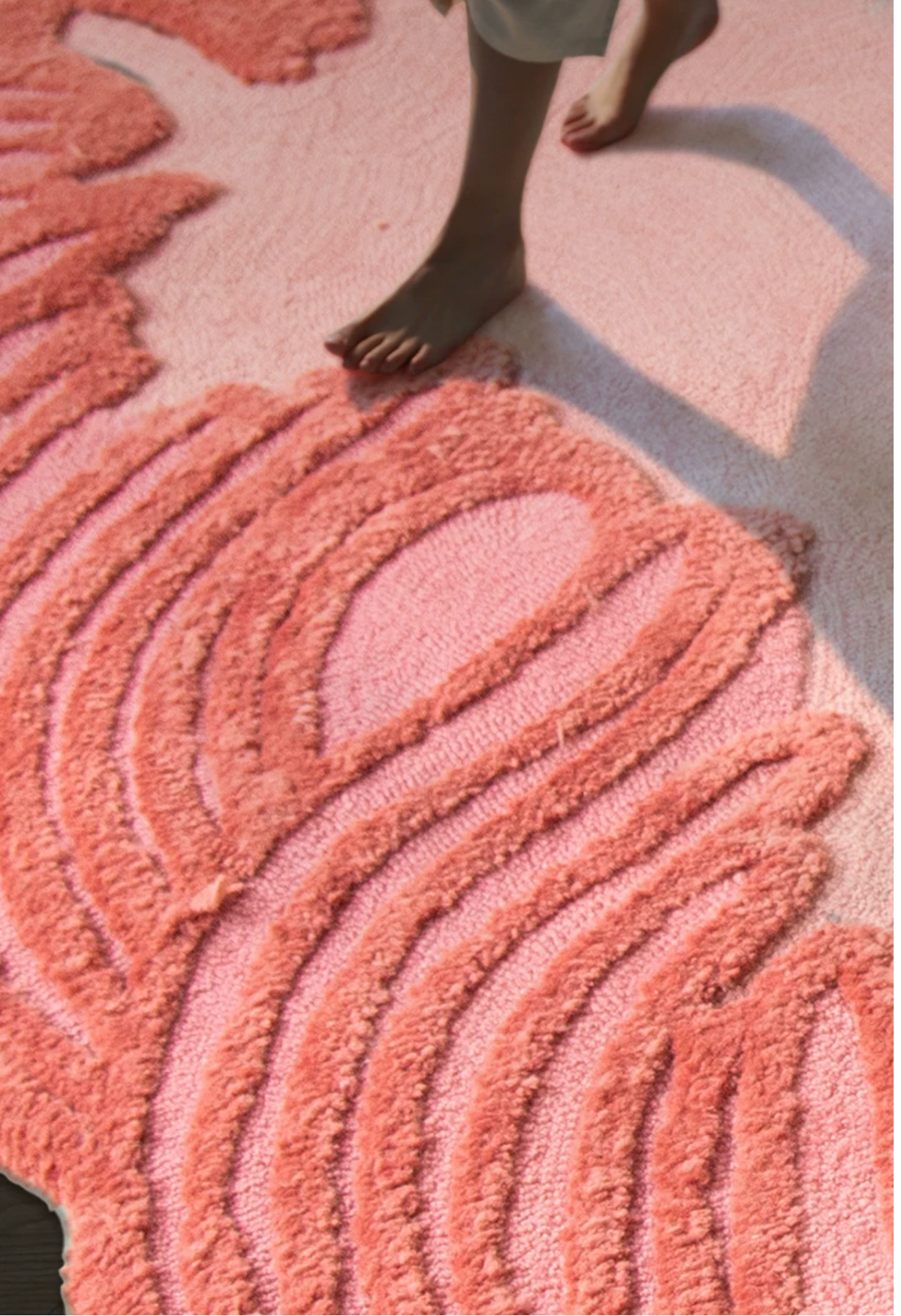 Hewn Earth Studio Camellia coral hand-woven rug with intricate pattern and soft texture, perfect for adding warmth to any space.