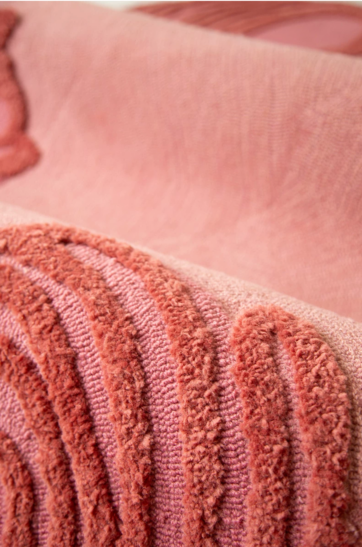 Close-up of Hewn Earth Studio Camellia coral rug featuring detailed floral pattern and vibrant woven texture.