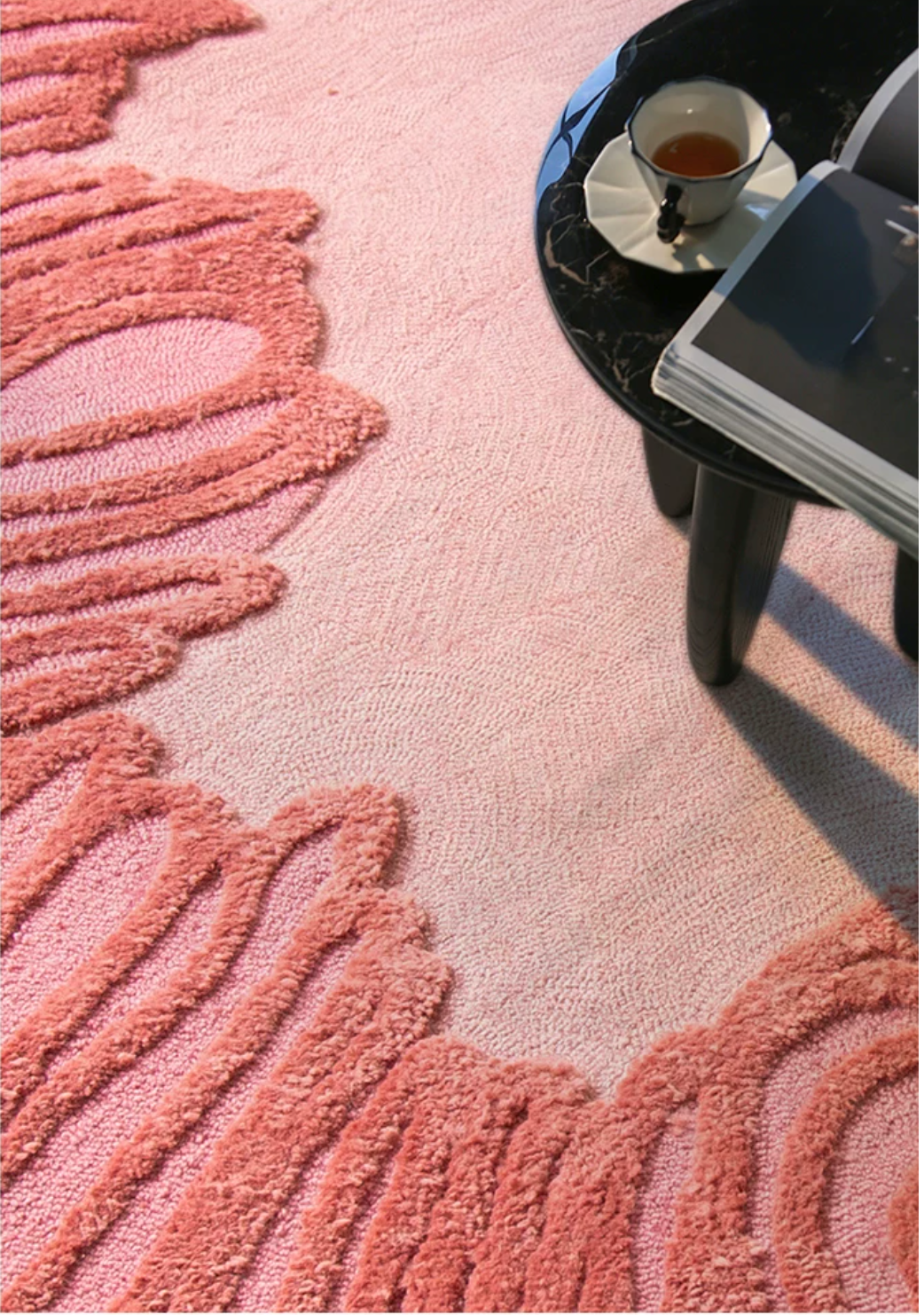 Coral-colored Camellia rug by Hewn Earth Studio featuring intricate floral patterns and a soft, textured surface.