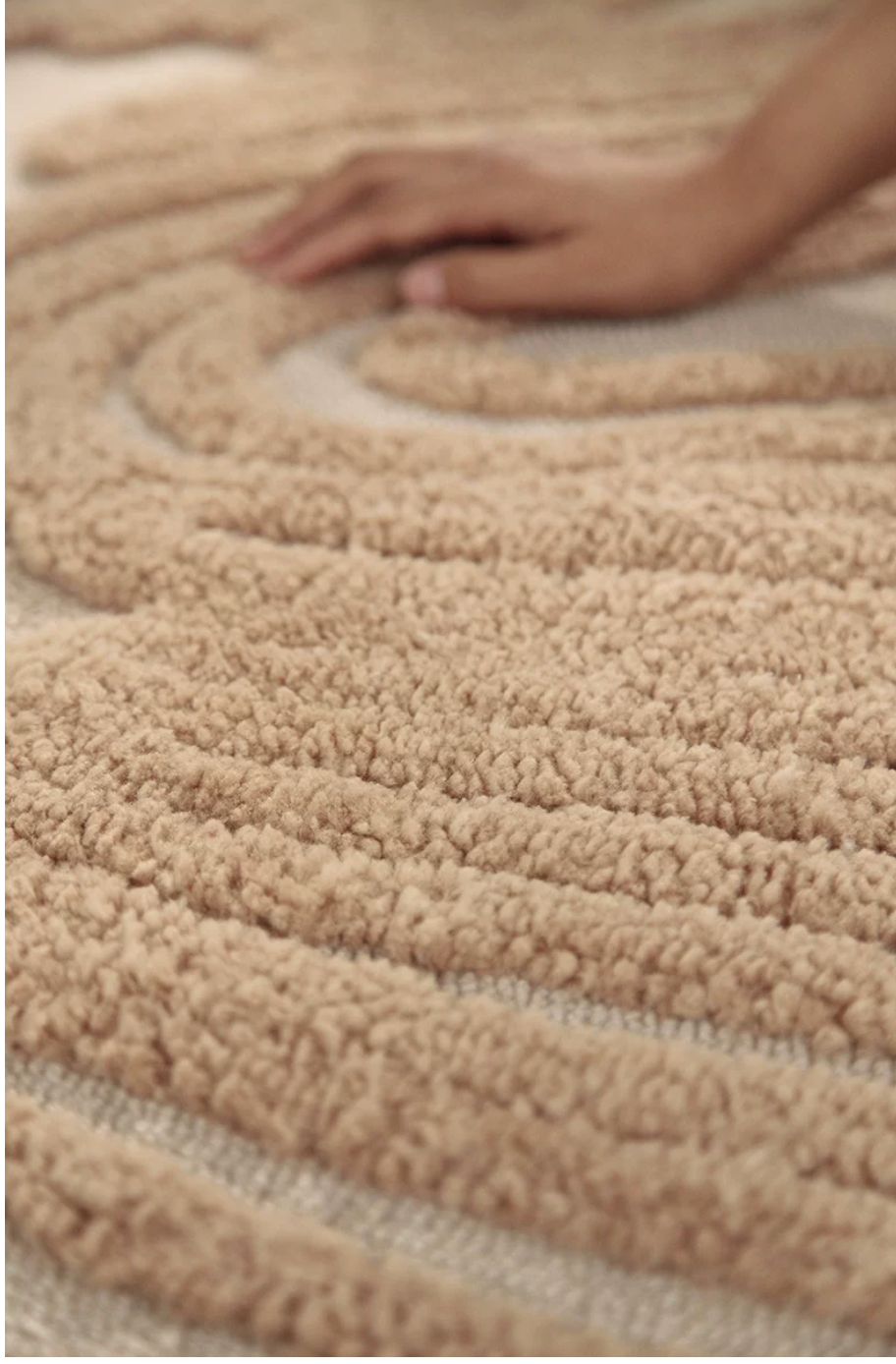 Hewn Earth Studio Camellia handwoven rug with intricate floral pattern and soft neutral colors.