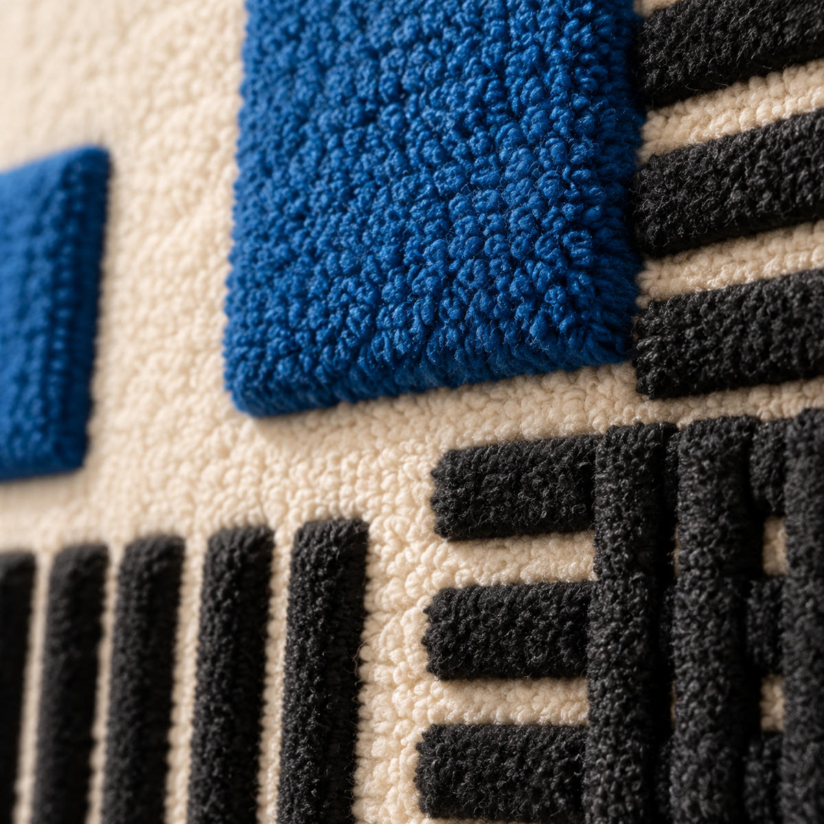 Close-up of Hewn Earth wall art featuring cobalt-colored blocks over black striped background, showcasing textured geometric design.